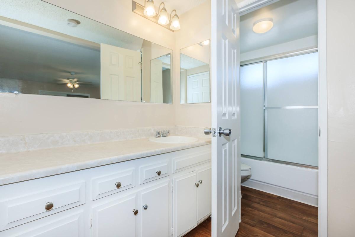 a white sink sitting under a window