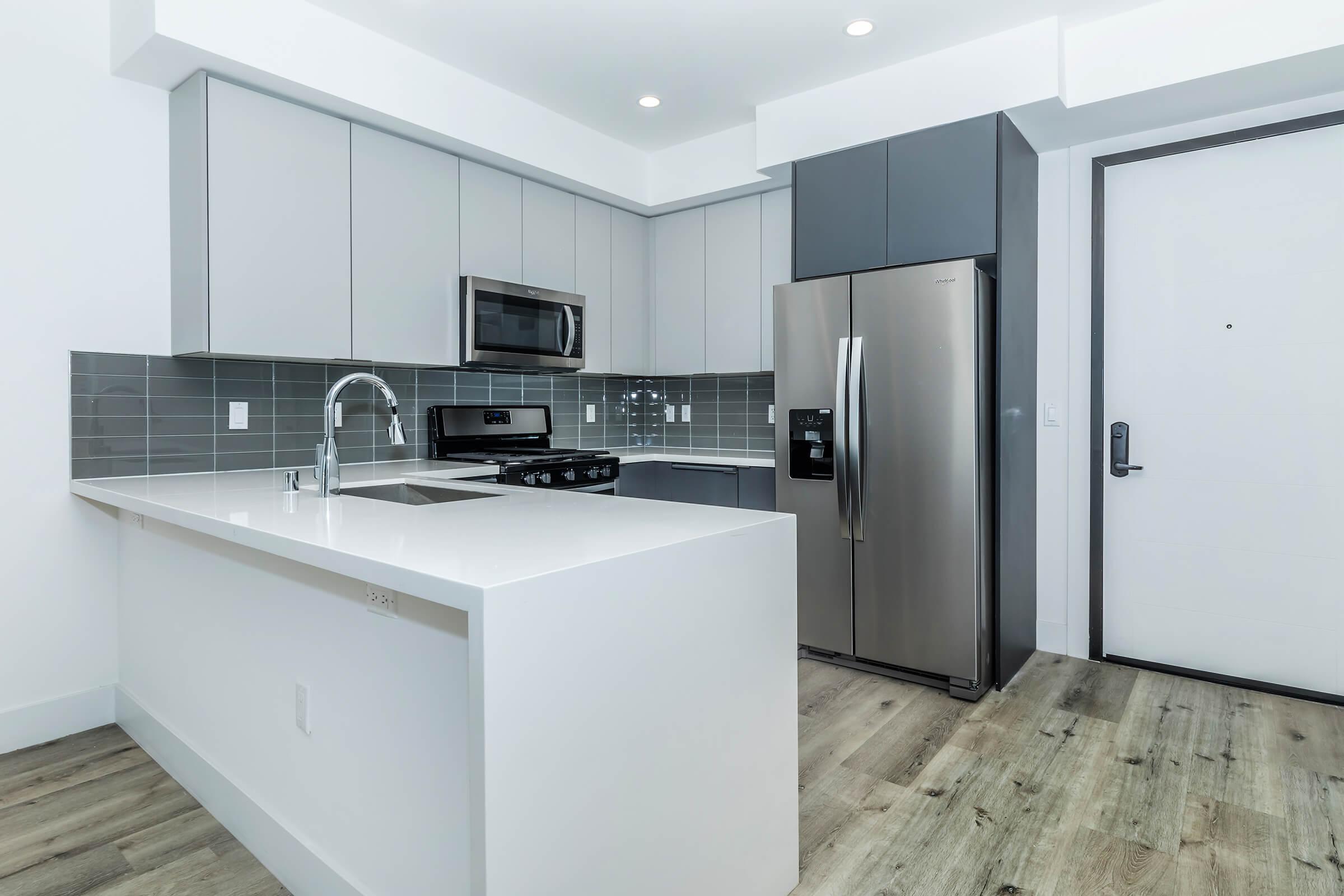 a kitchen with a sink and a refrigerator