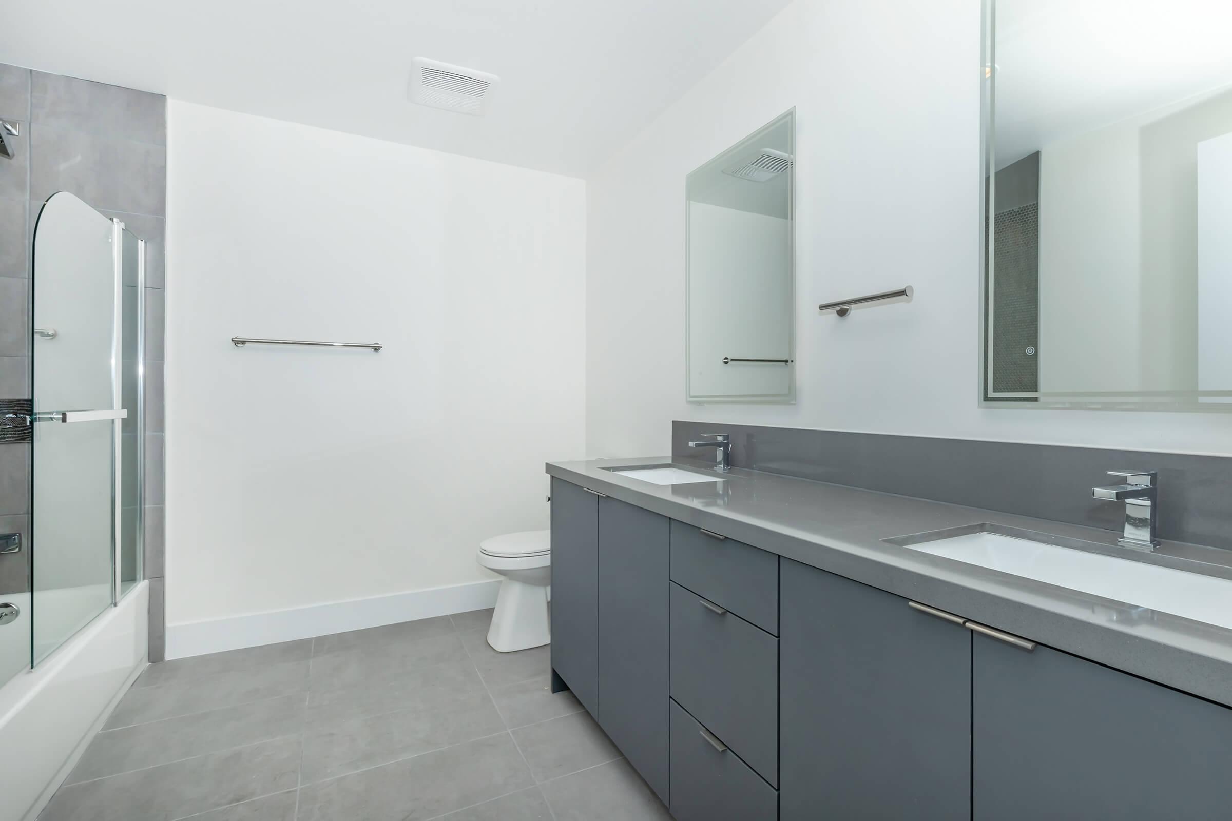 a kitchen with a sink and a mirror