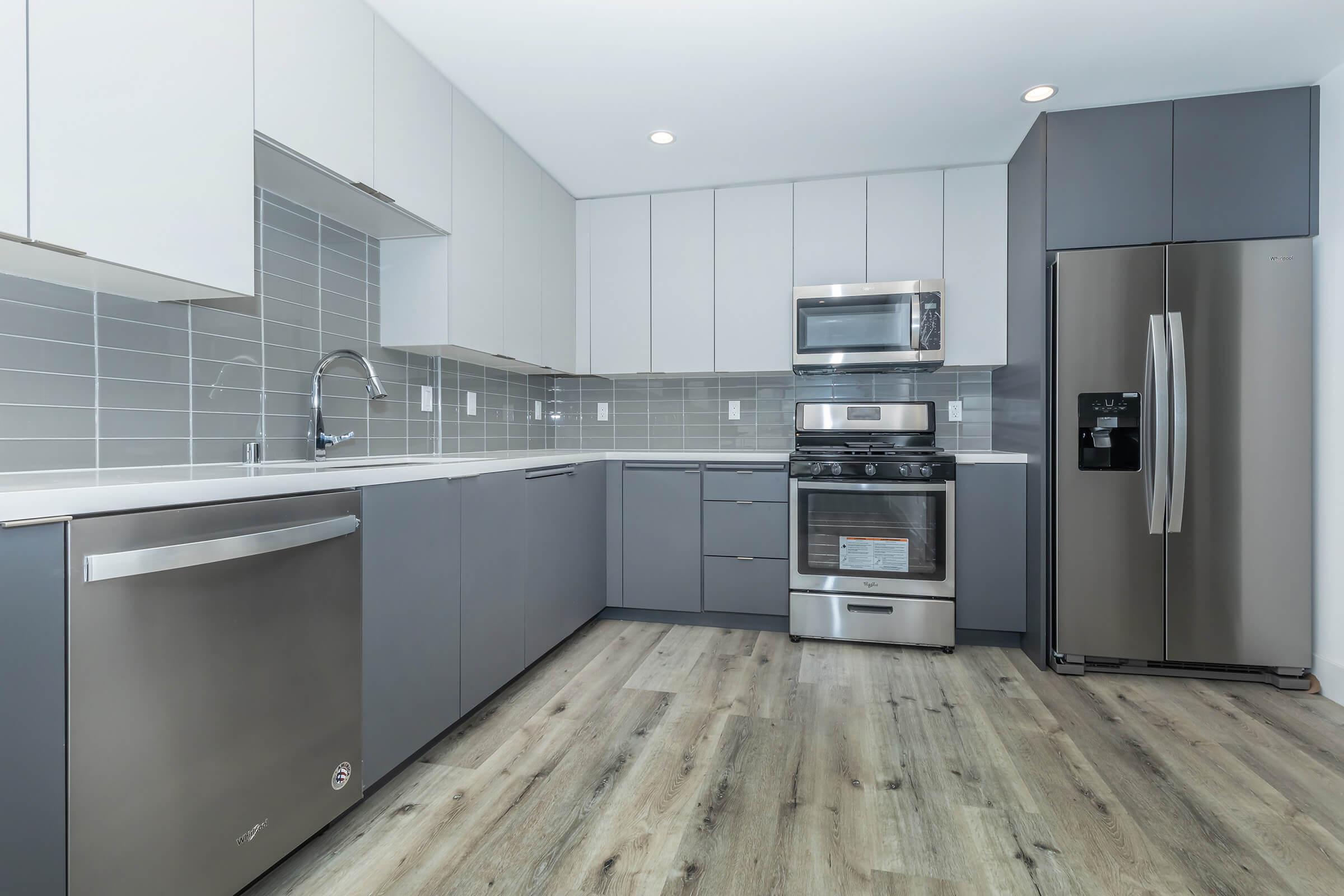 a large kitchen with stainless steel appliances