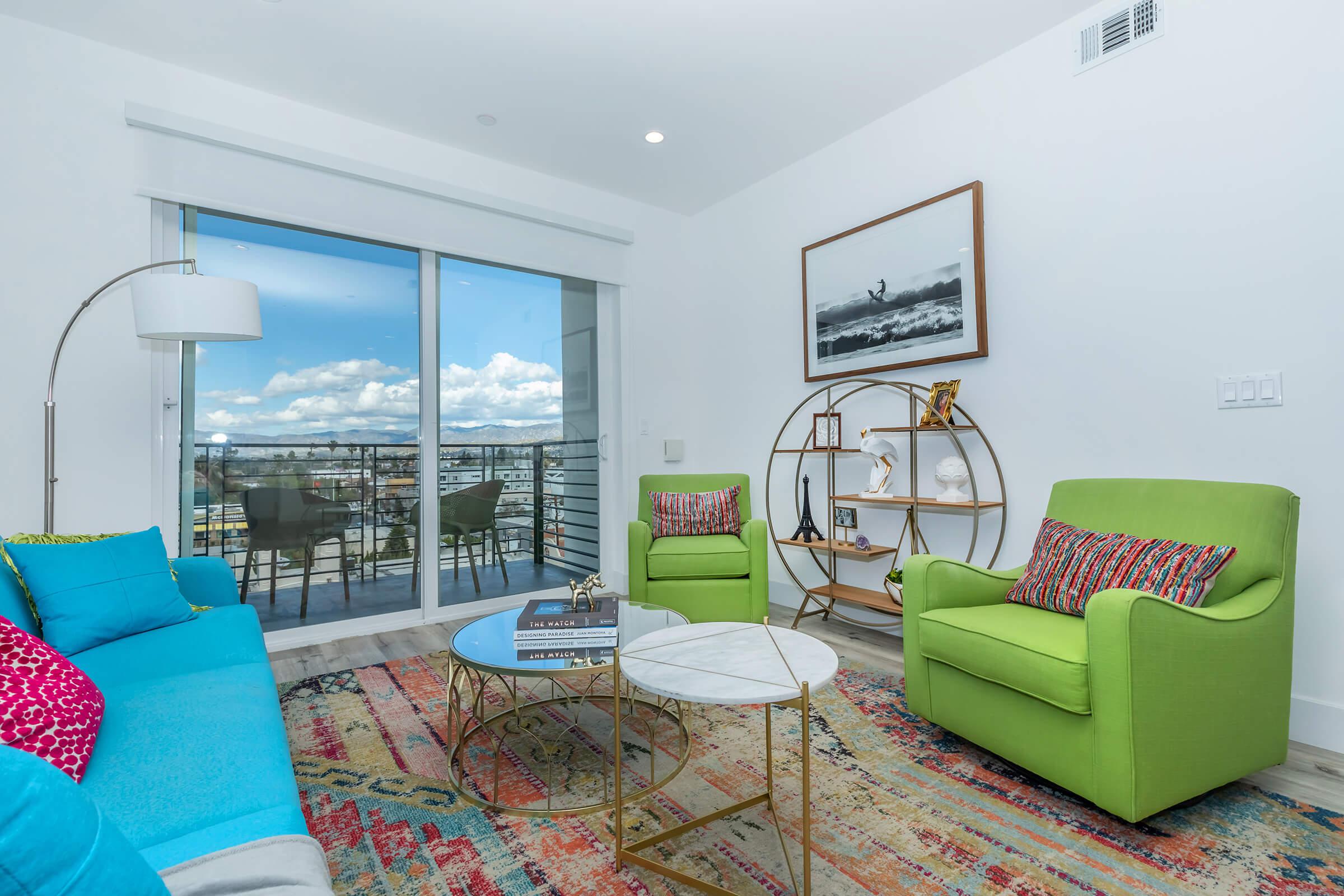 a living room filled with furniture and a large window