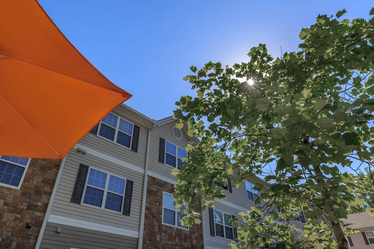 a red umbrella in front of a building