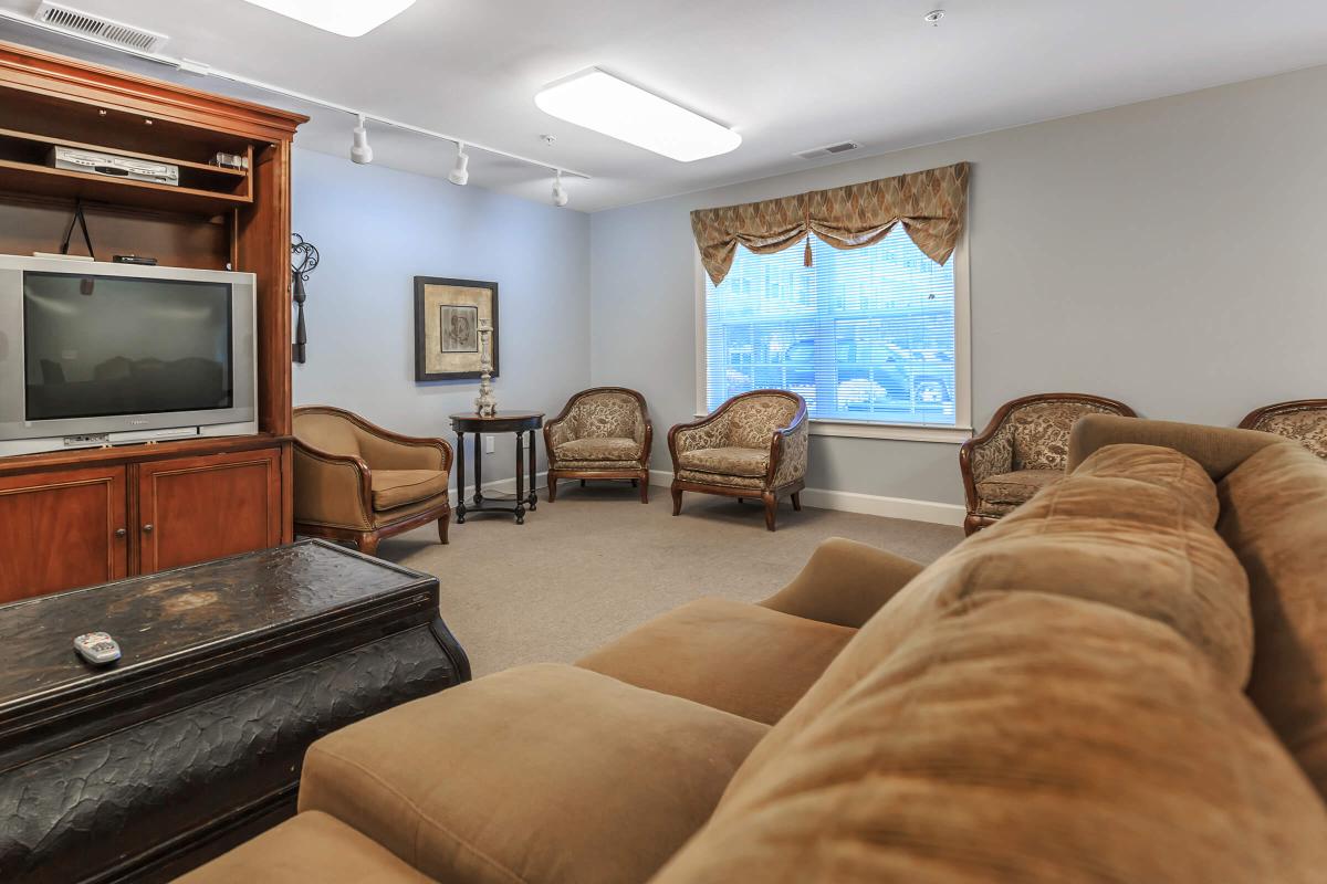 a living room filled with furniture and a flat screen tv