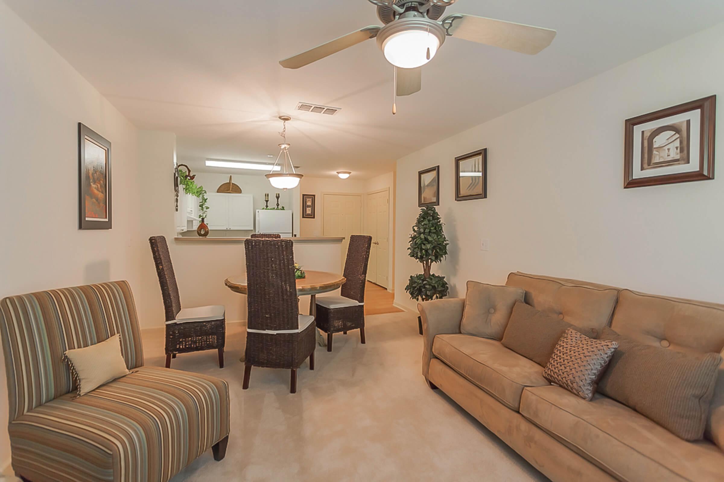 a living room filled with furniture and a flat screen tv