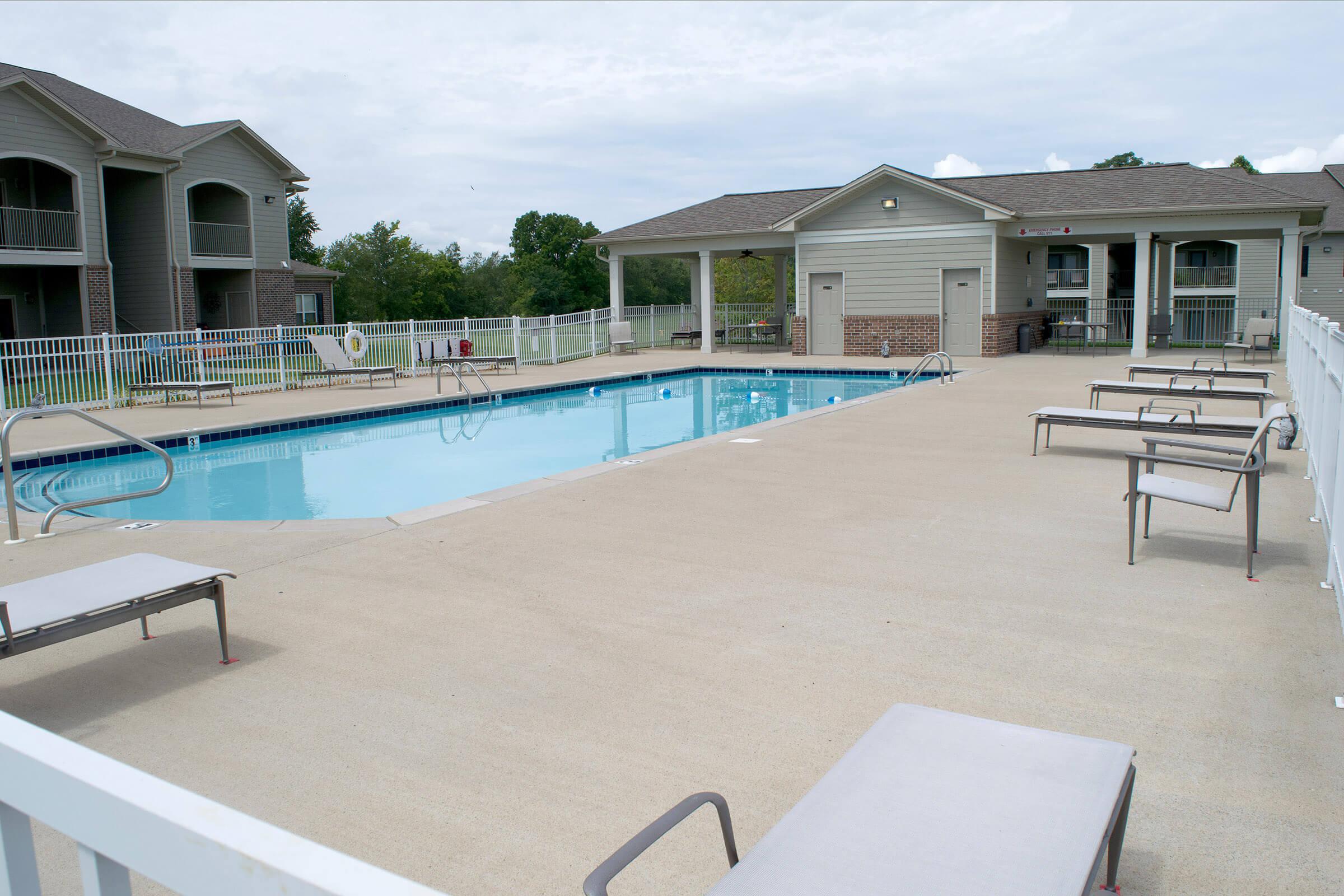 a house with a pool in front of a building