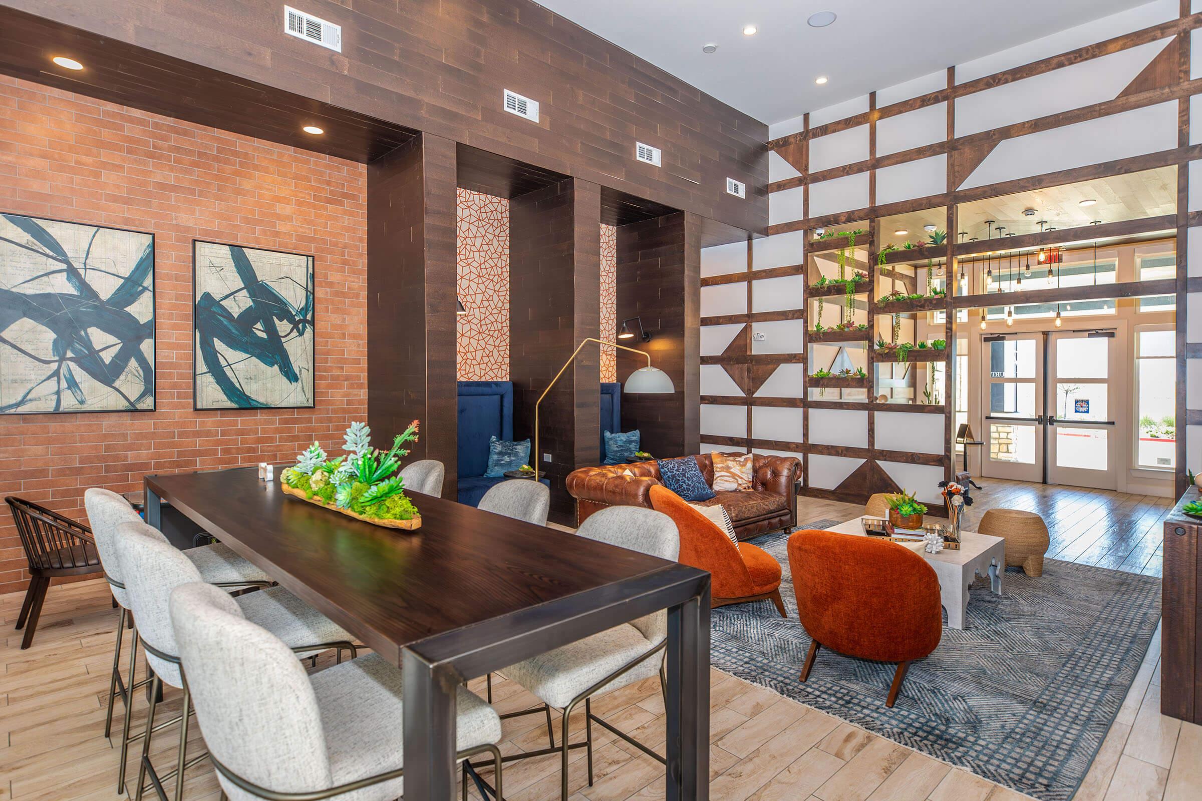 a living room filled with furniture and vase of flowers on a table