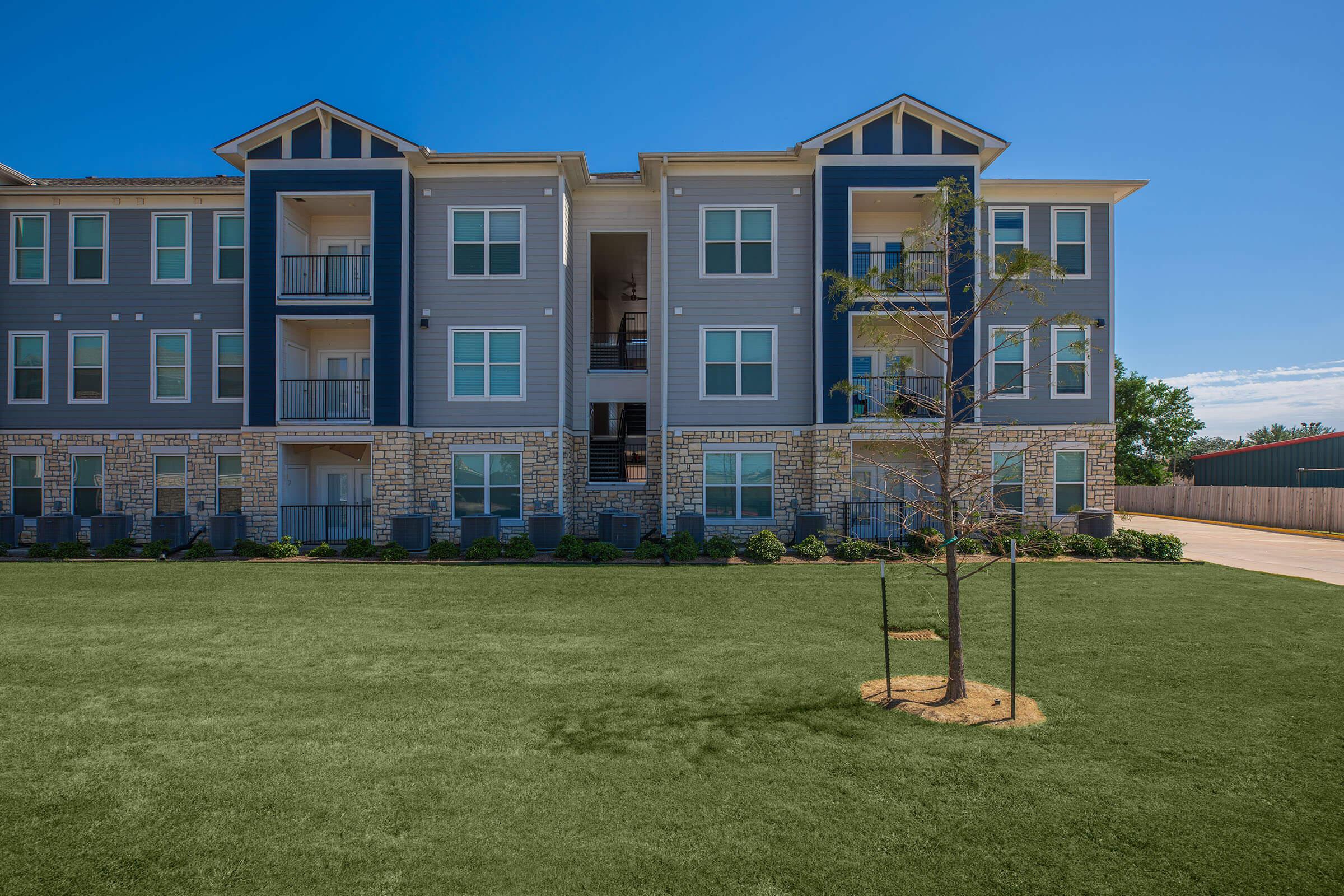 a building with a grassy field