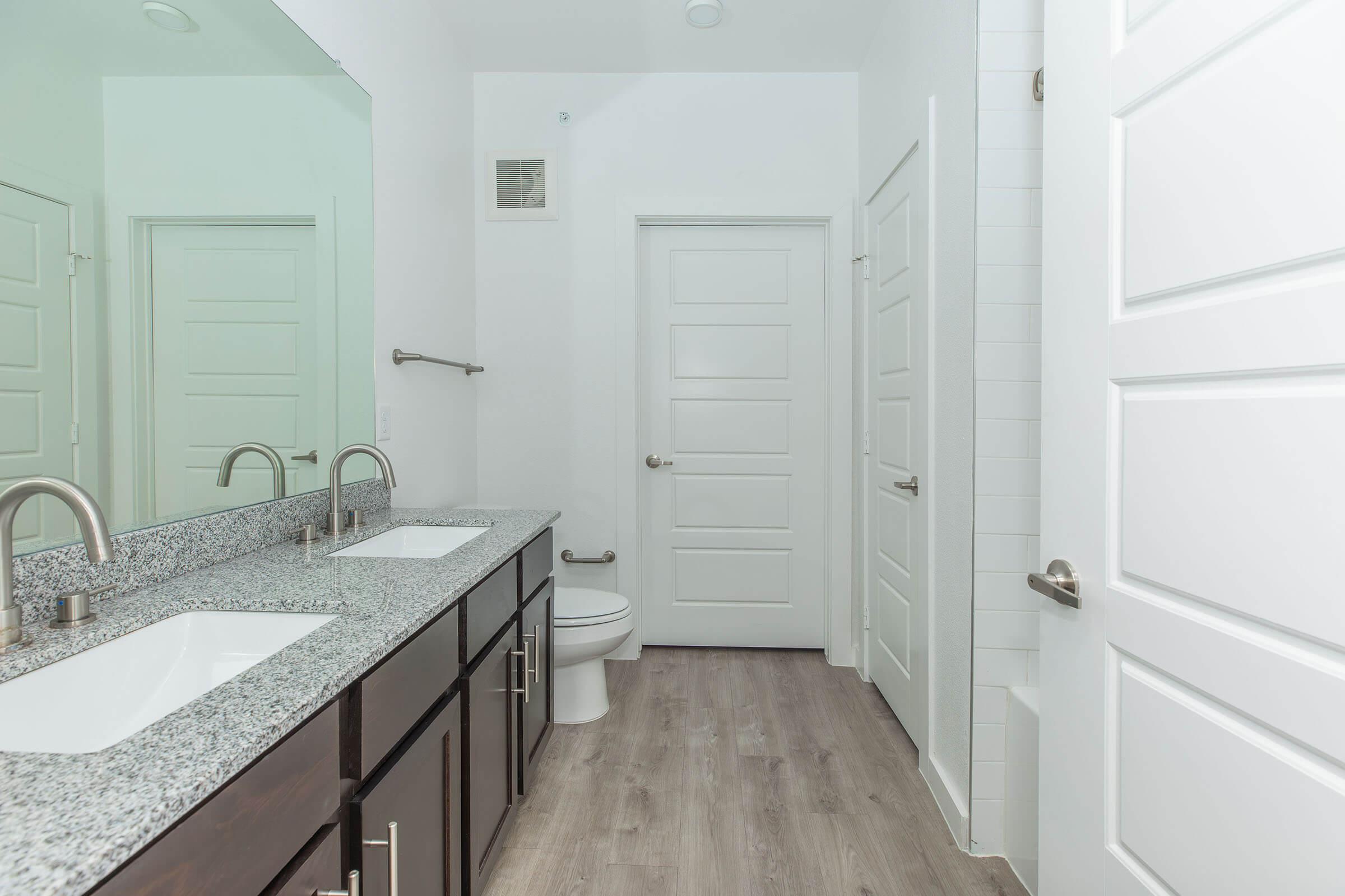 a kitchen with a sink and a mirror