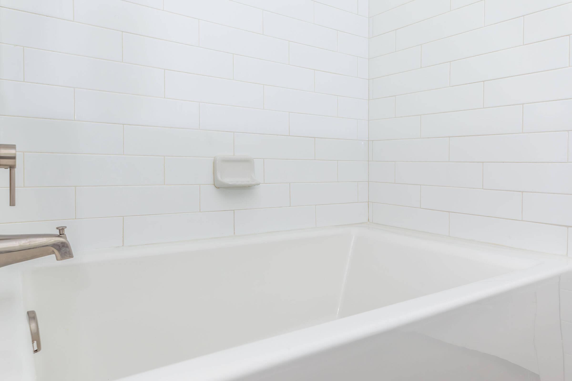 a large tub next to a sink