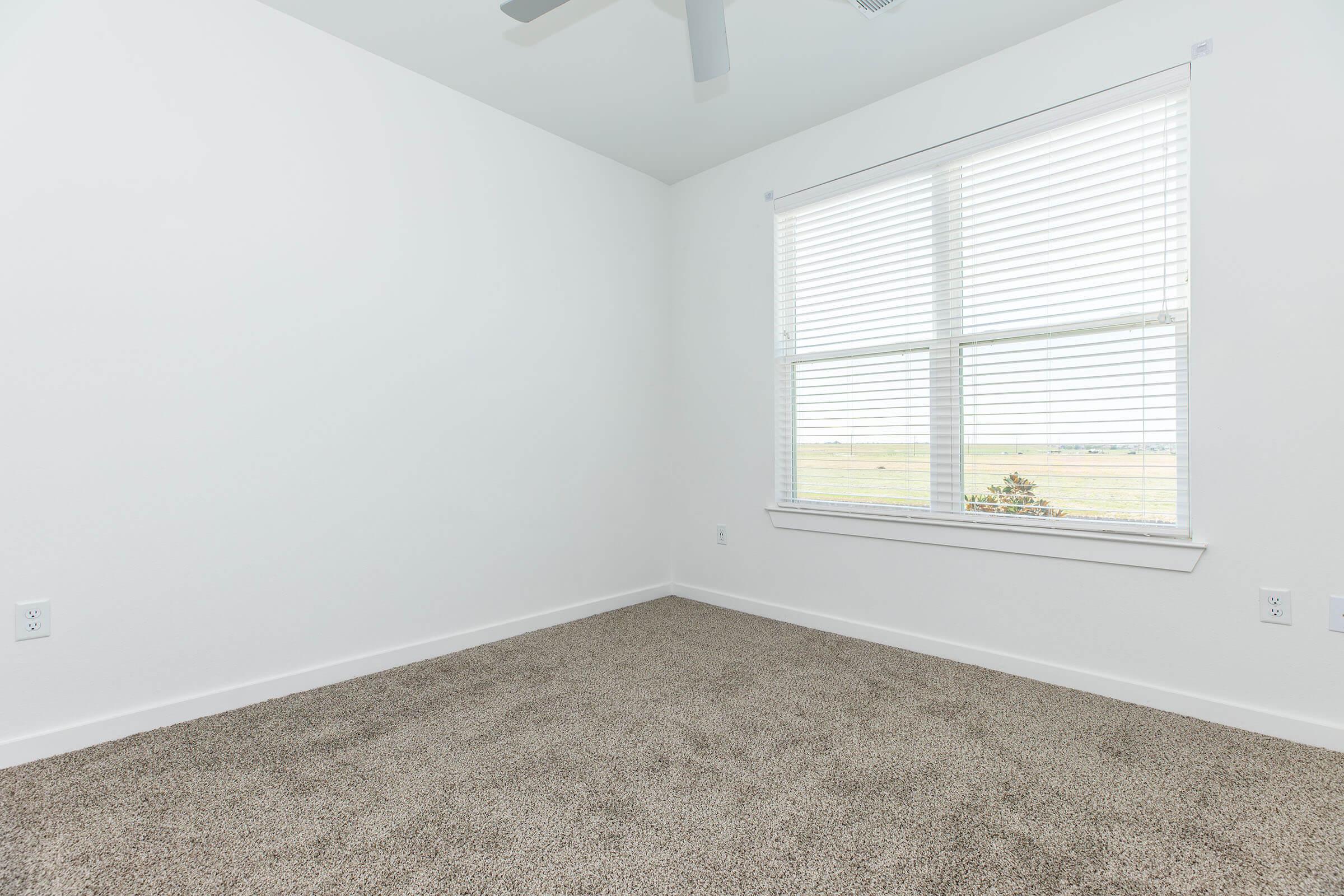 a bedroom with a large window