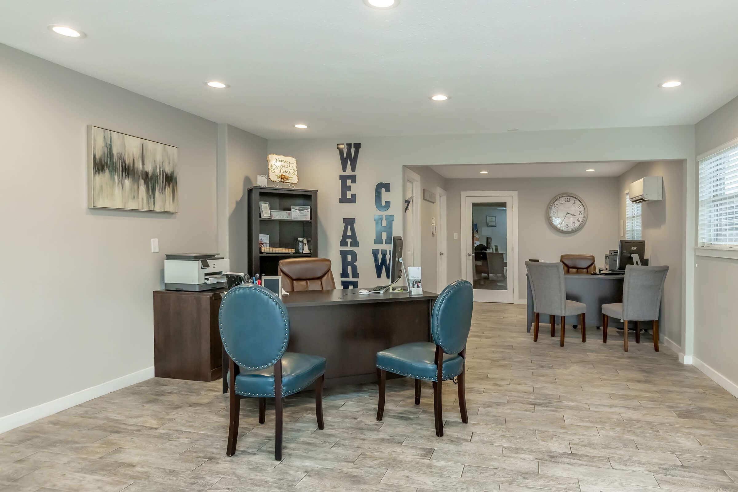 a living room filled with furniture on top of a wooden floor