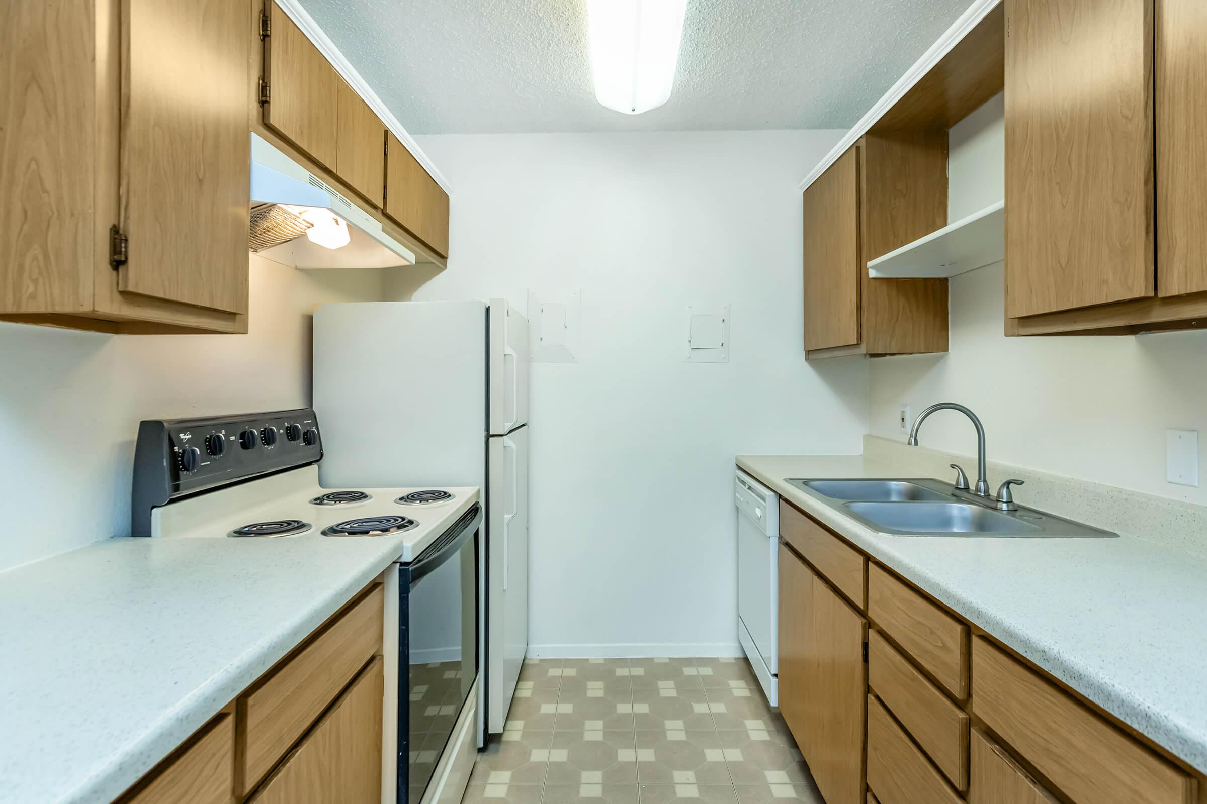 a kitchen with a sink and a mirror