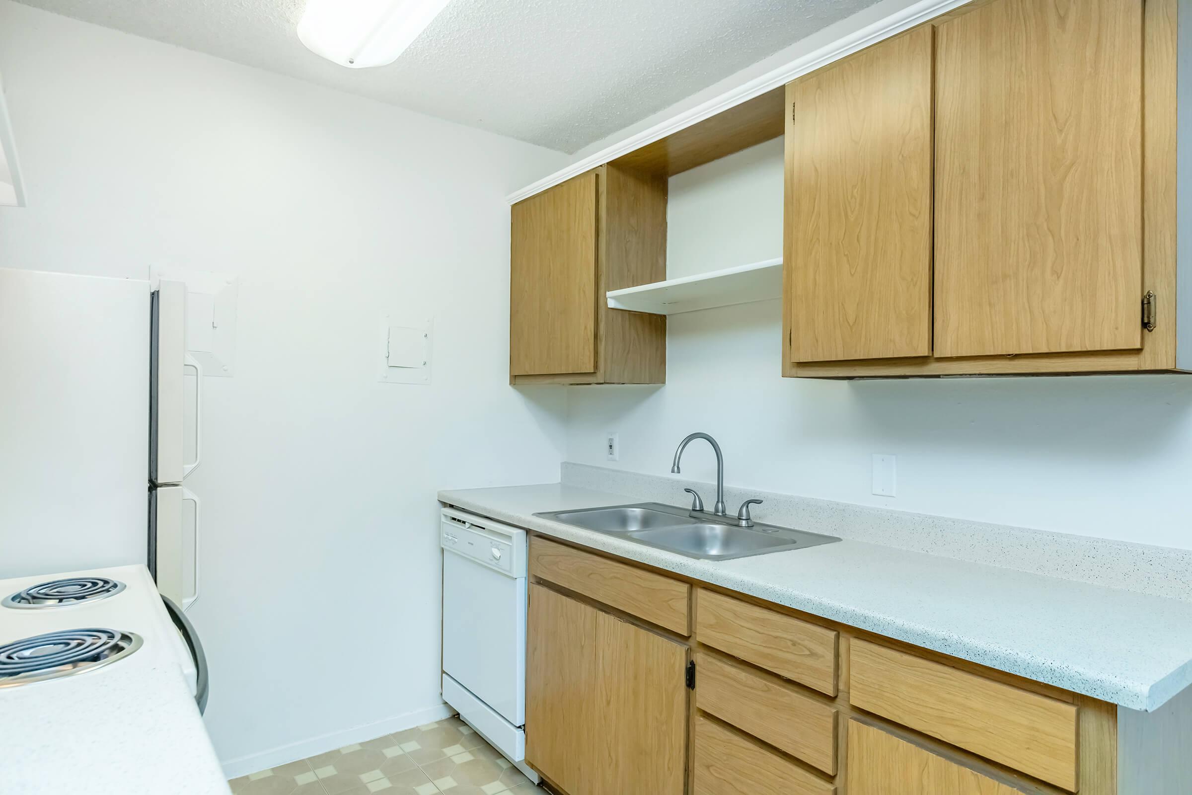 a kitchen with stainless steel appliances and wooden cabinets