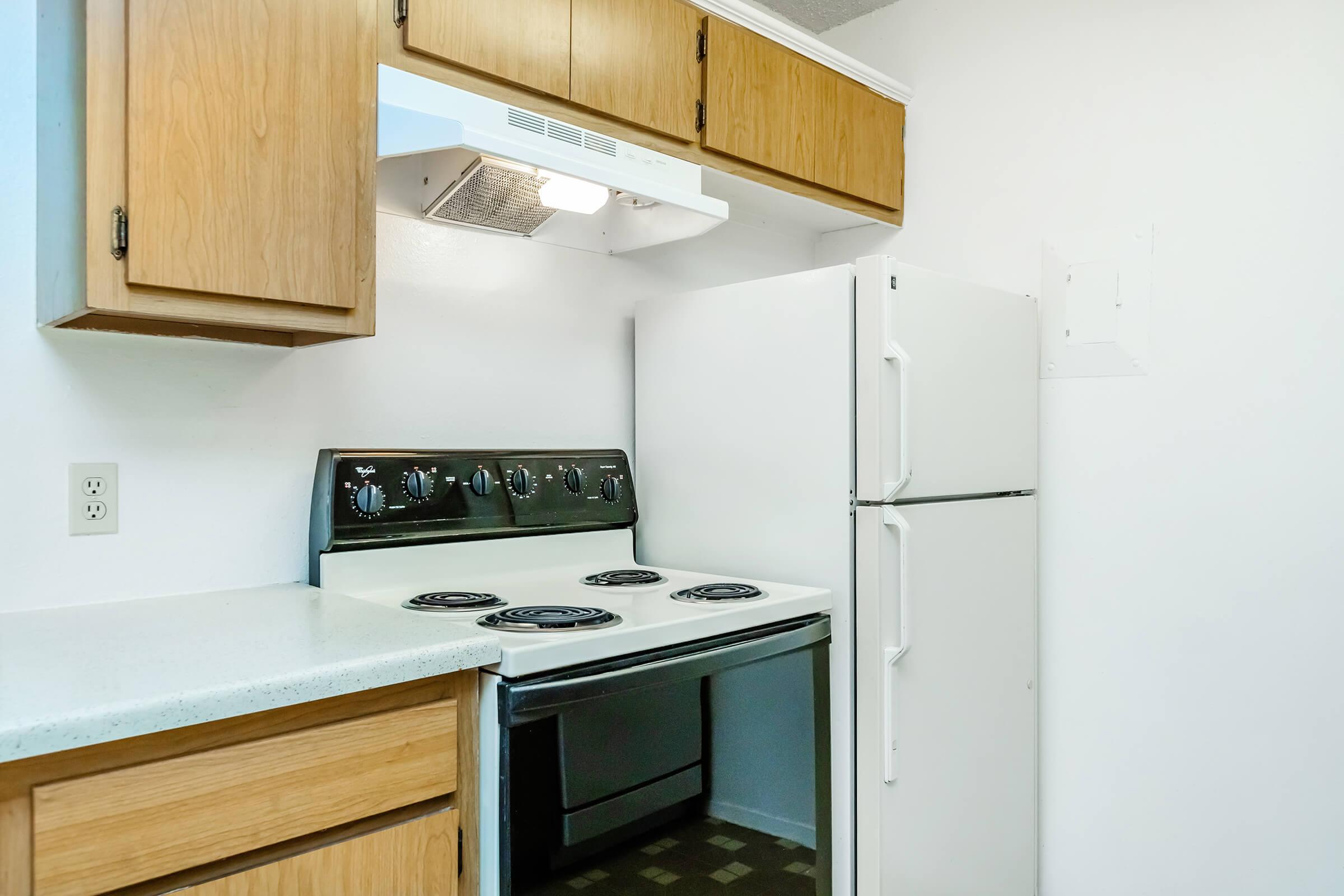 a stove top oven sitting inside of a kitchen