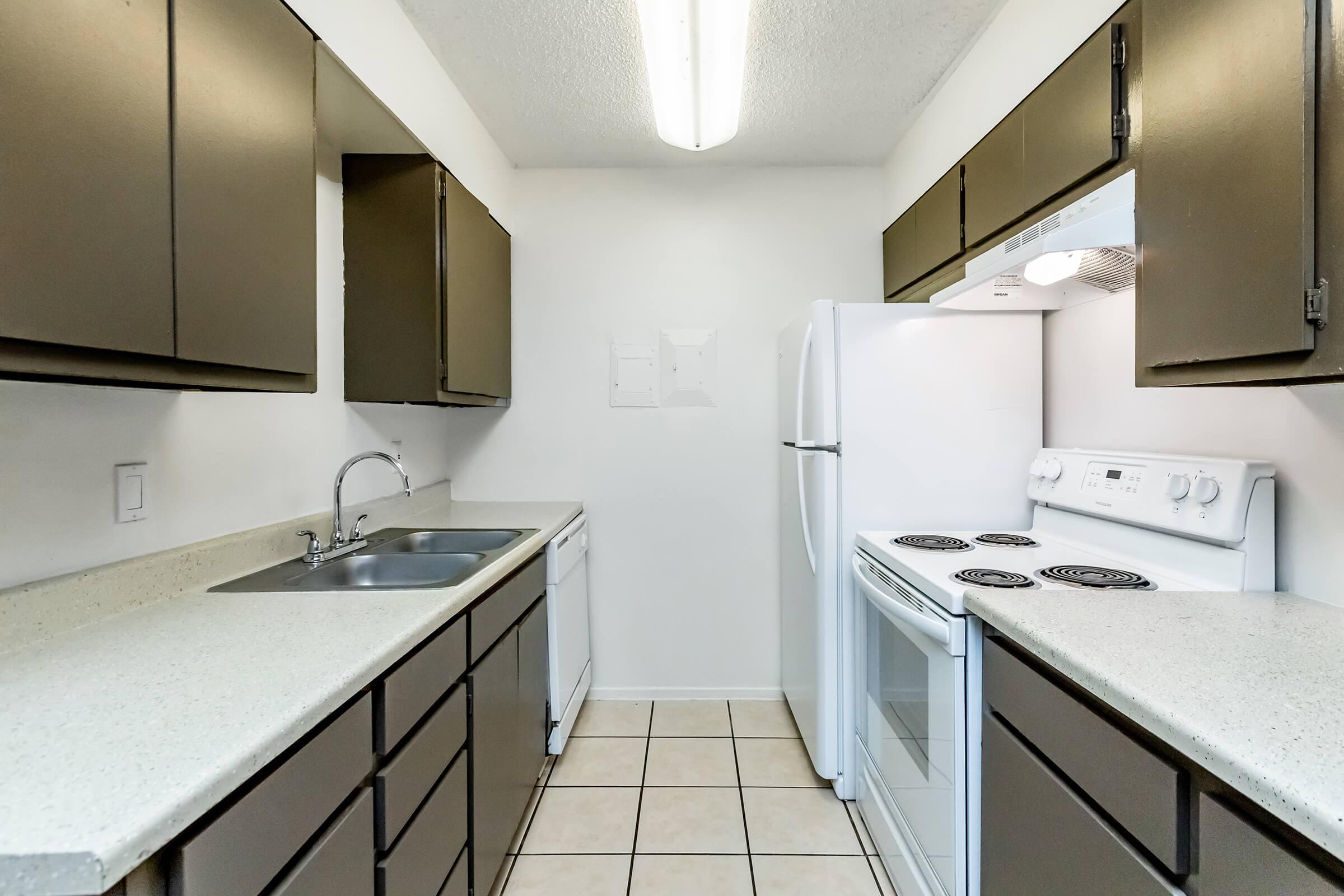 a kitchen with a stove and a sink