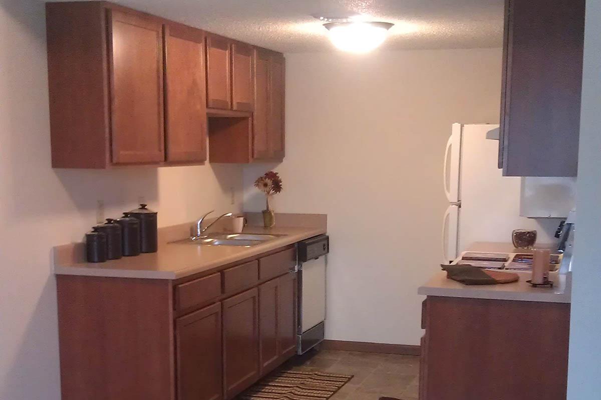 a kitchen with a sink and a mirror