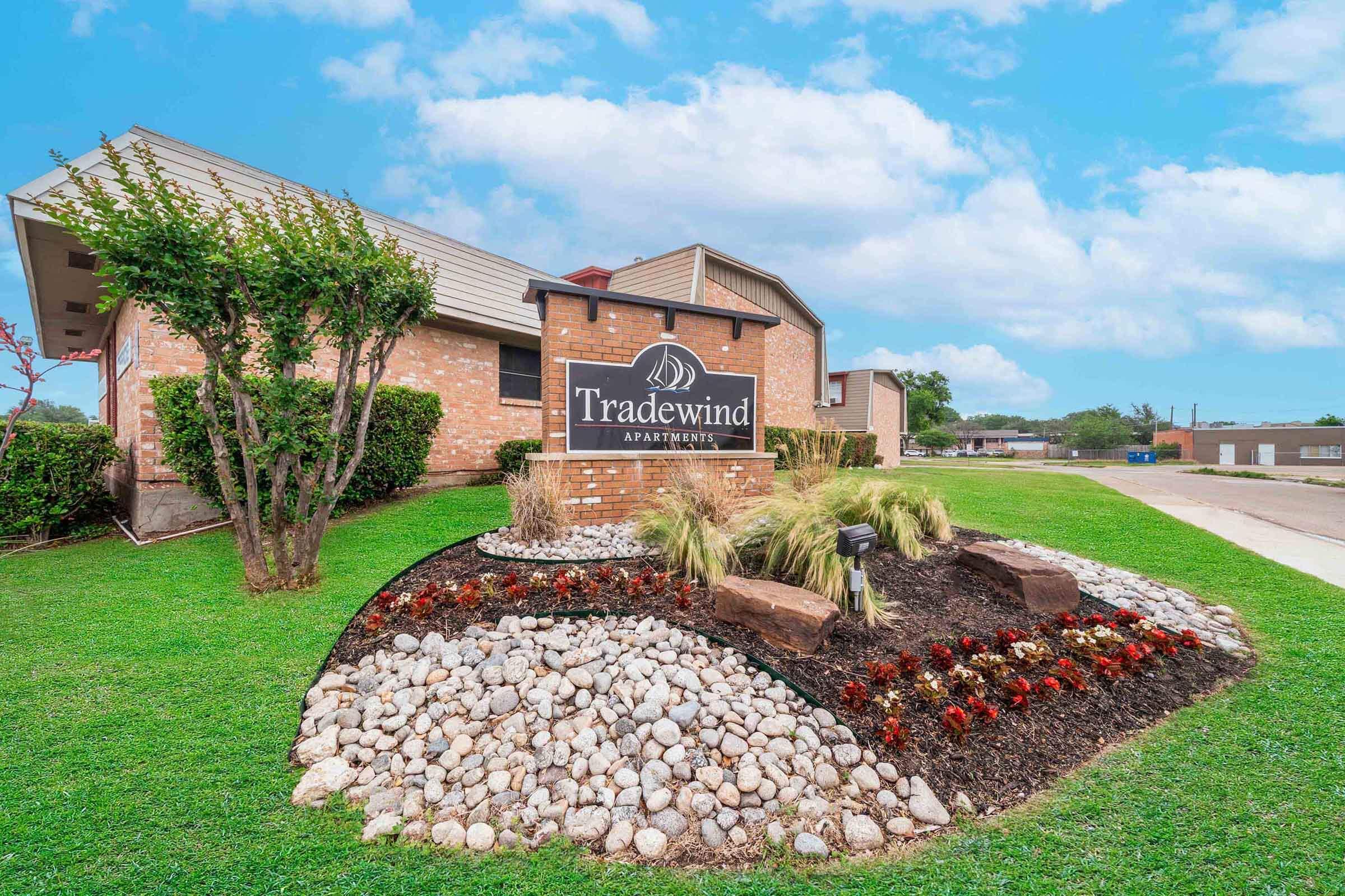 a large lawn in front of a brick building