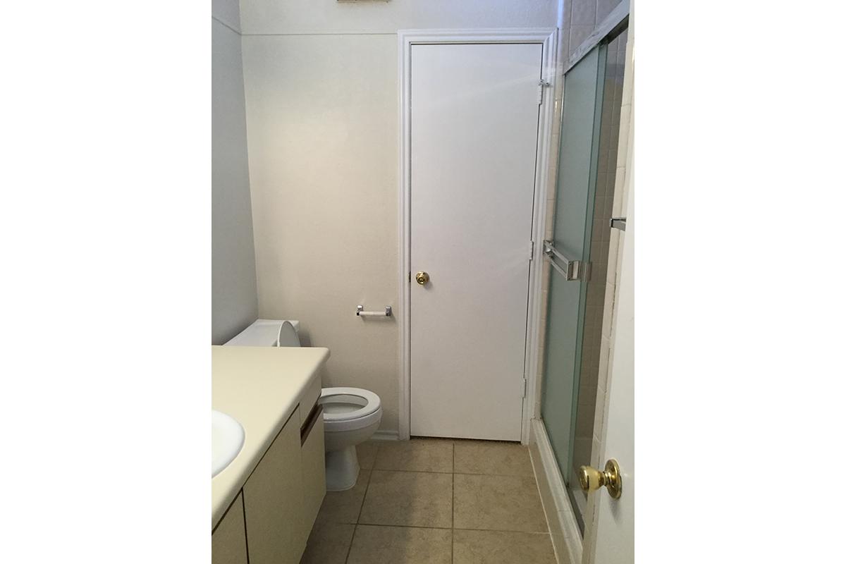 a white sink sitting next to a door