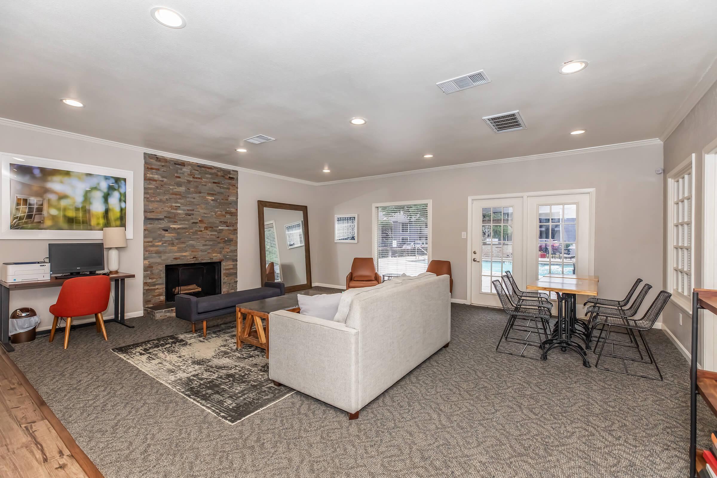 a living room filled with furniture and a large window