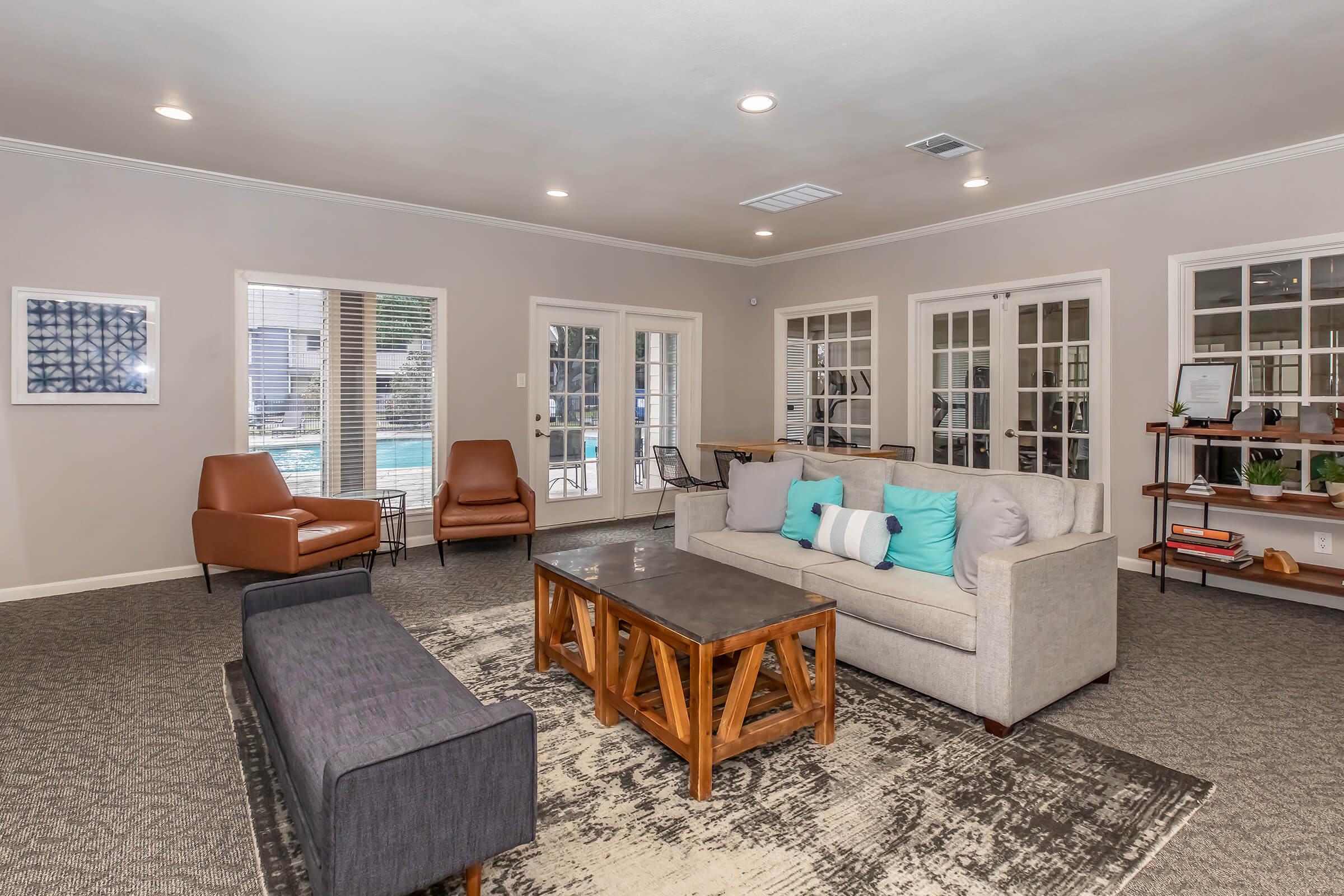 a living room filled with furniture and a large window