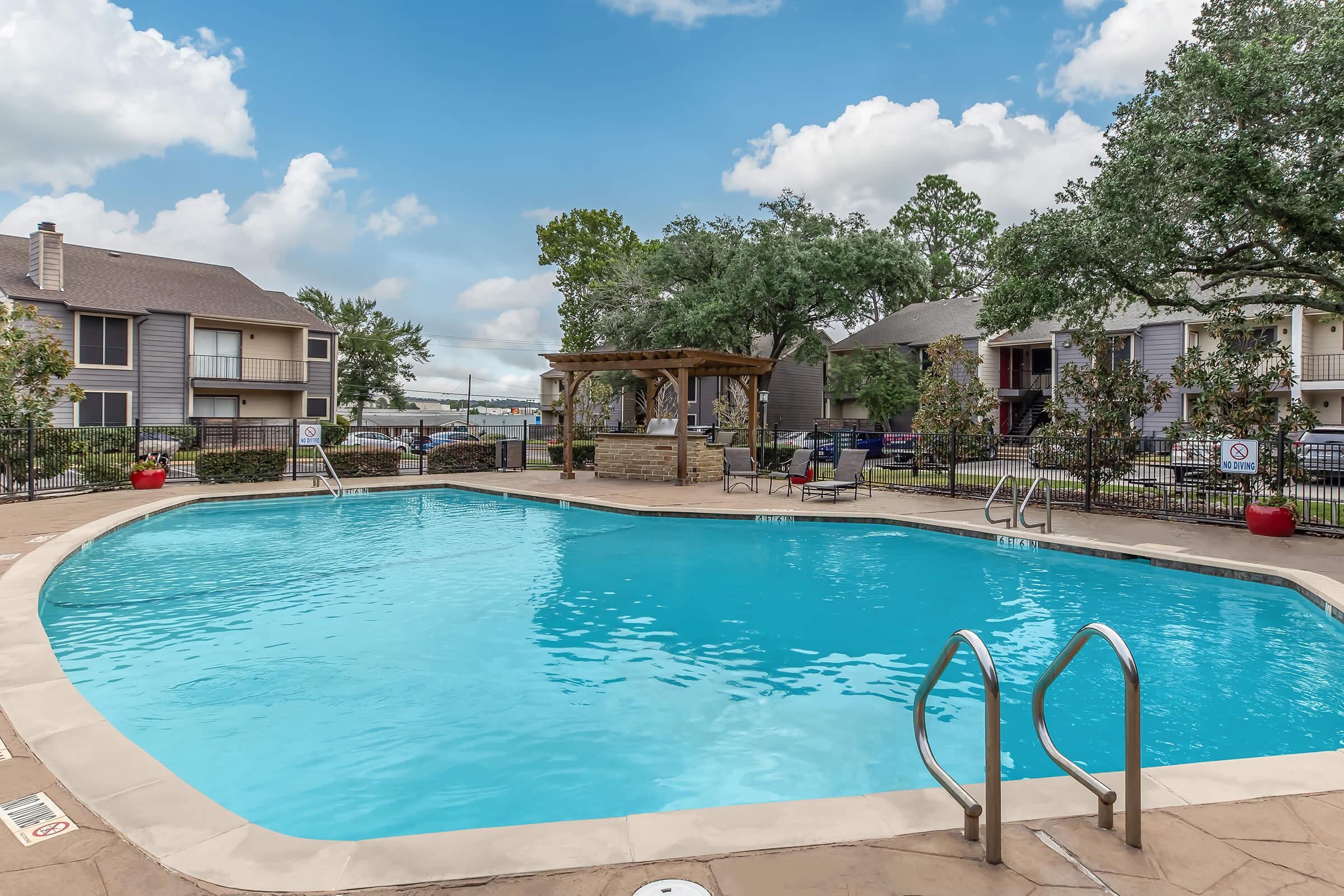 a large pool of water in front of a house