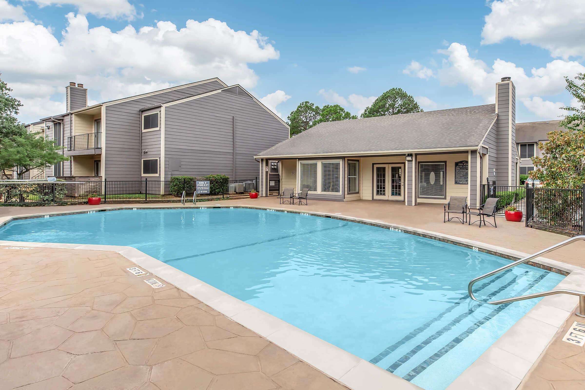 a house with a pool in front of a building