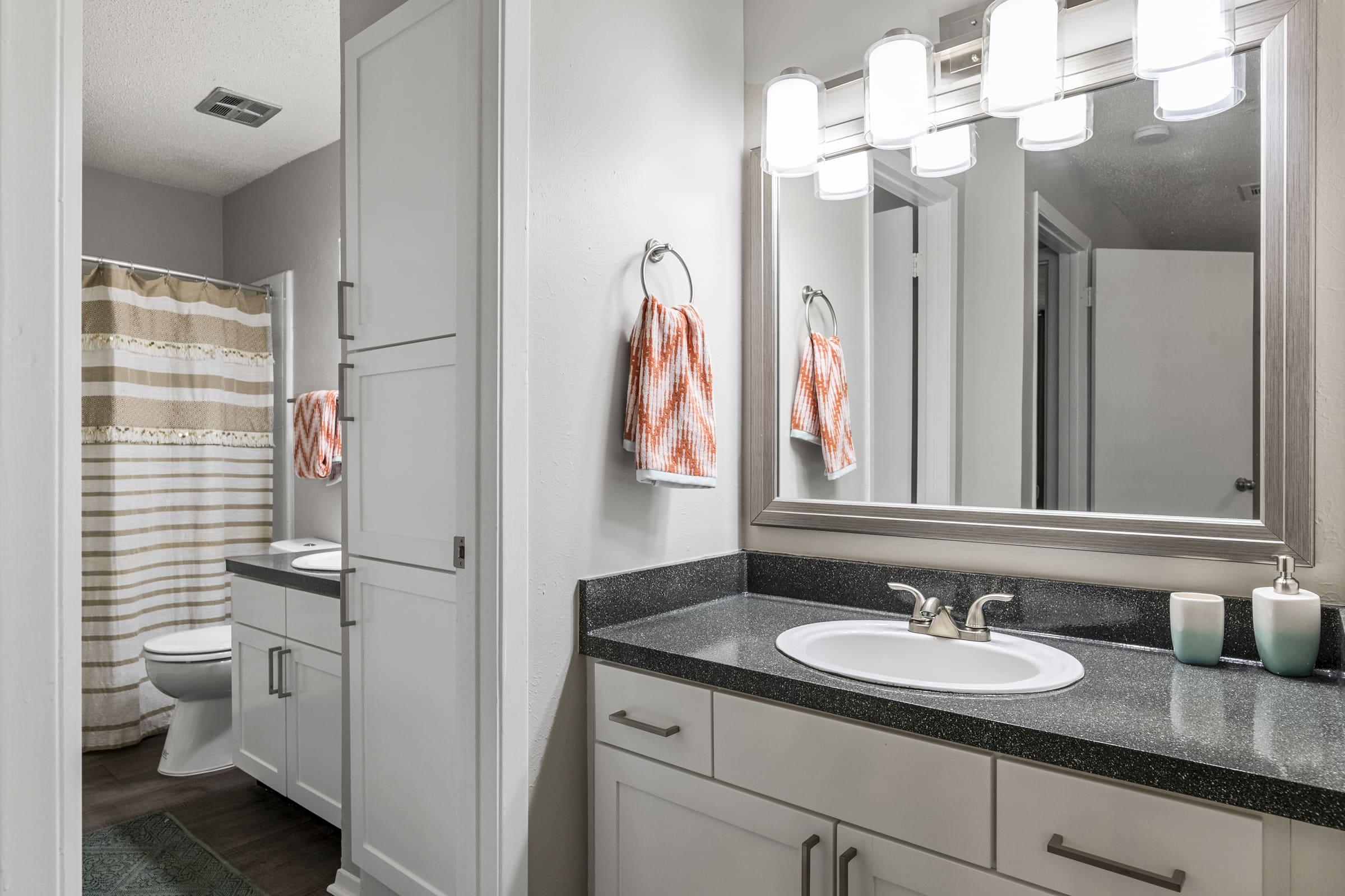 a kitchen with a sink and a mirror