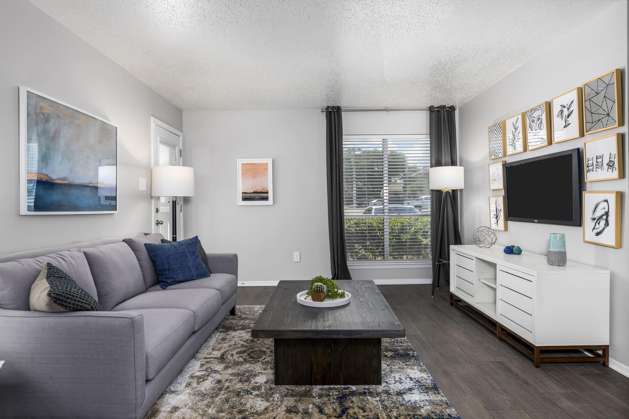 a living room filled with furniture and a large window