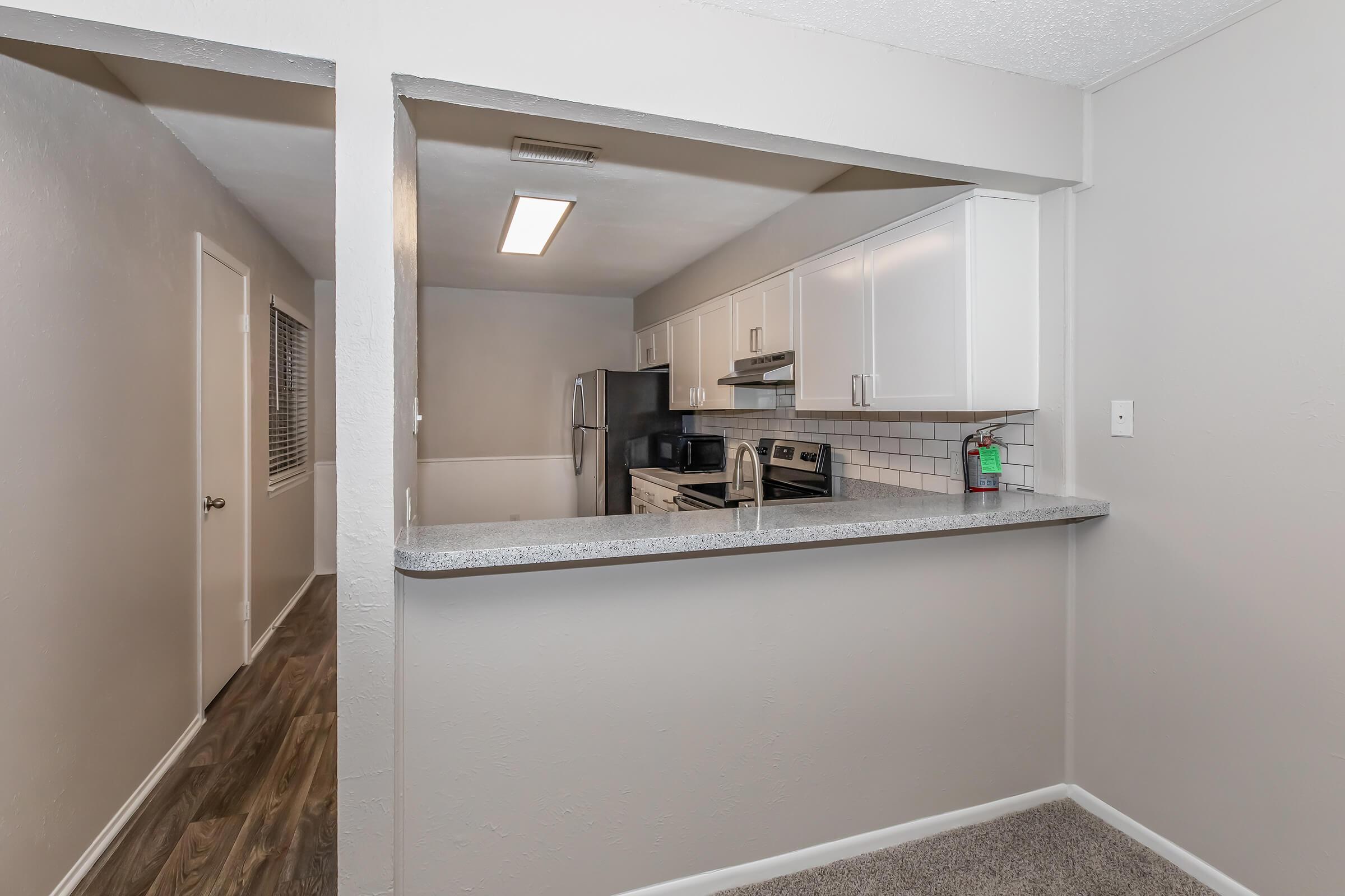 a kitchen with a sink and a mirror