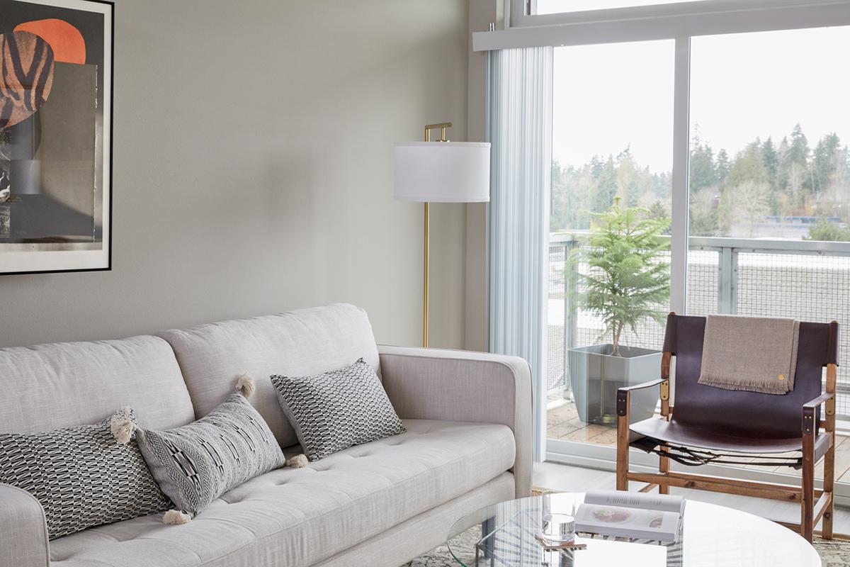 a living room filled with furniture and a large window