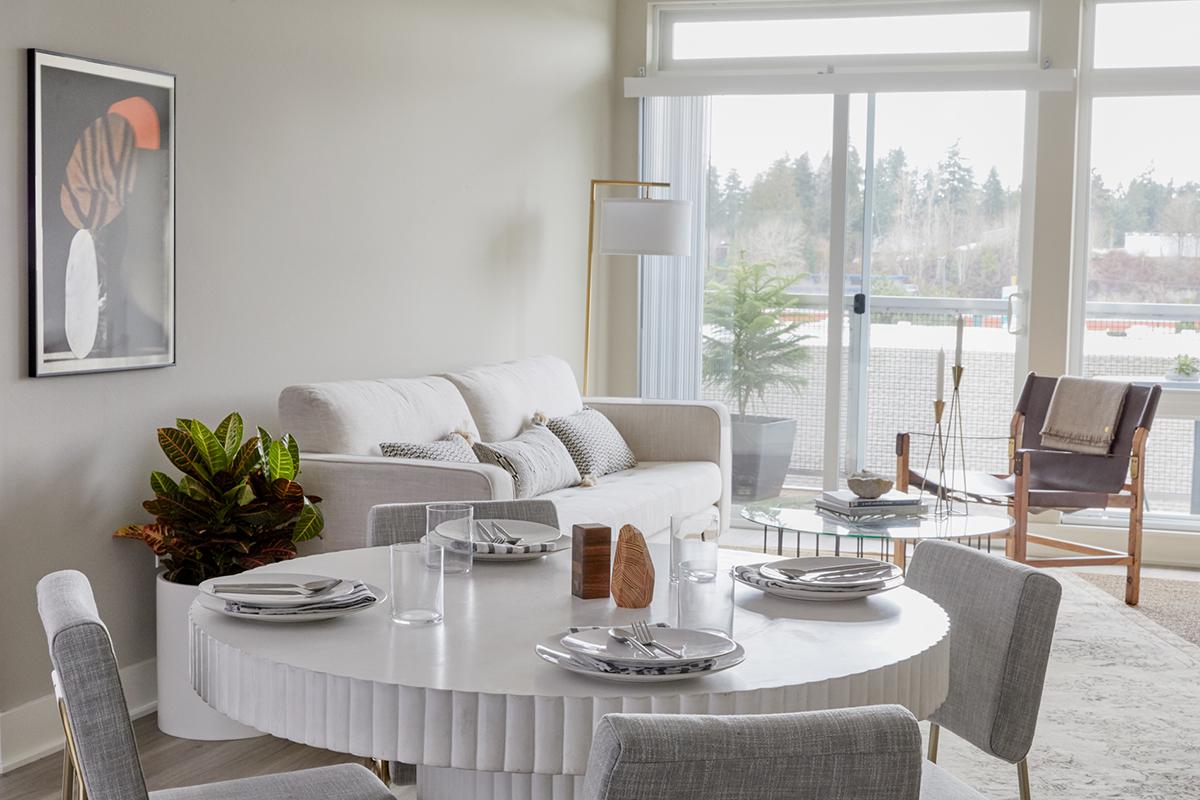 a living room filled with furniture and a large window