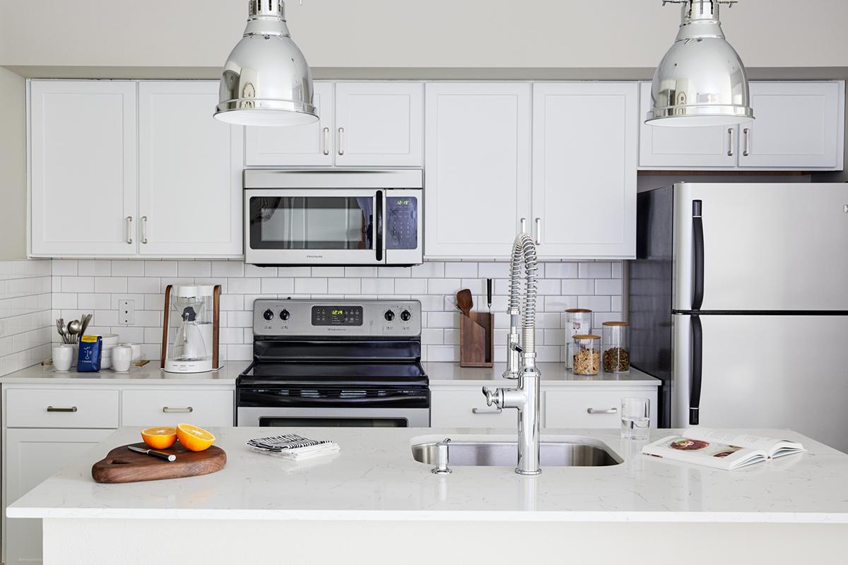 a kitchen with a sink and a microwave