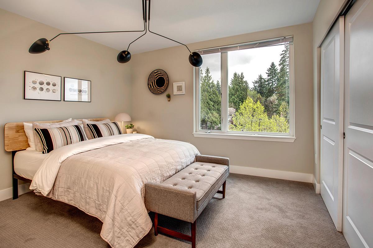 a bedroom with a bed and desk in a room