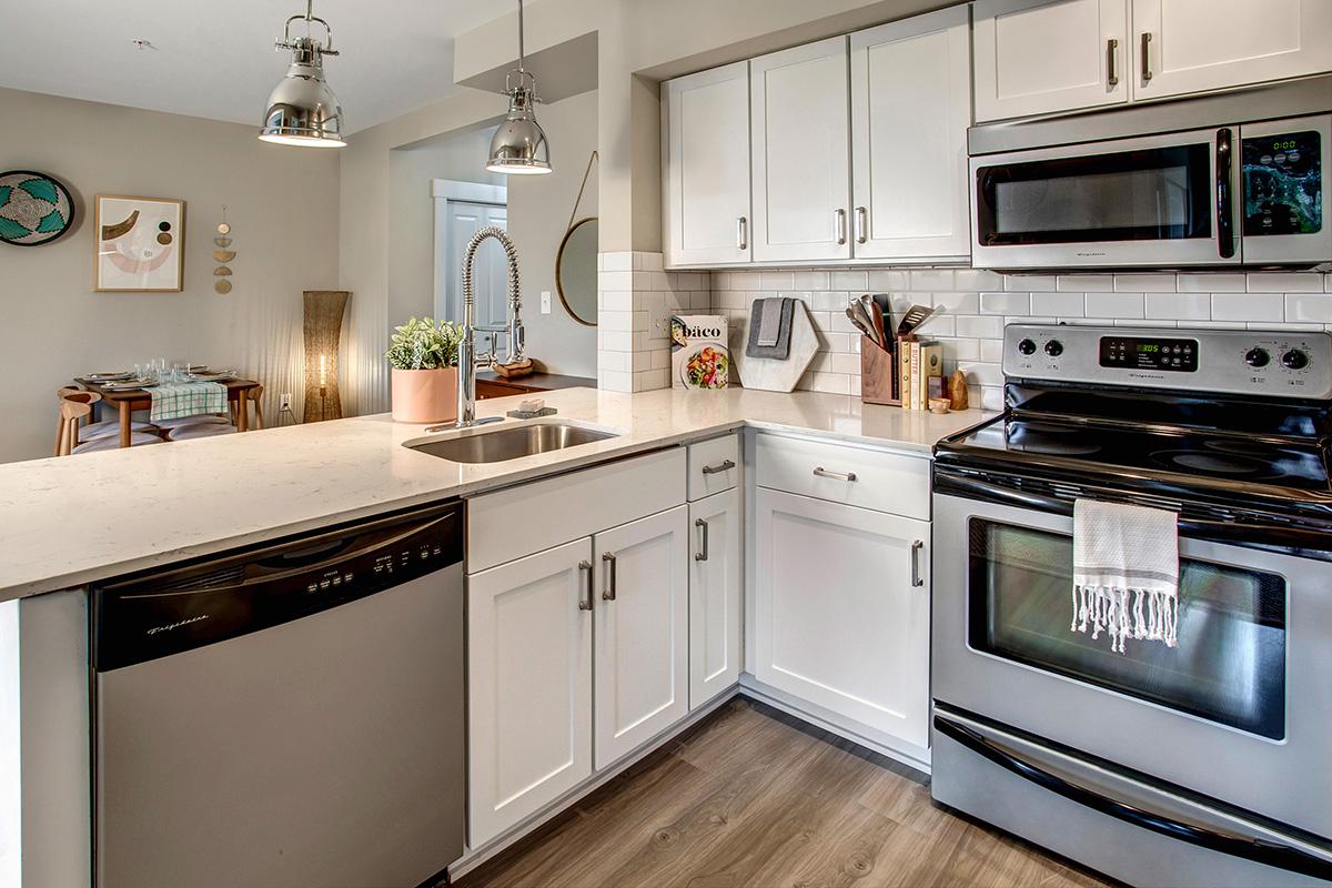 a stove top oven sitting inside of a kitchen