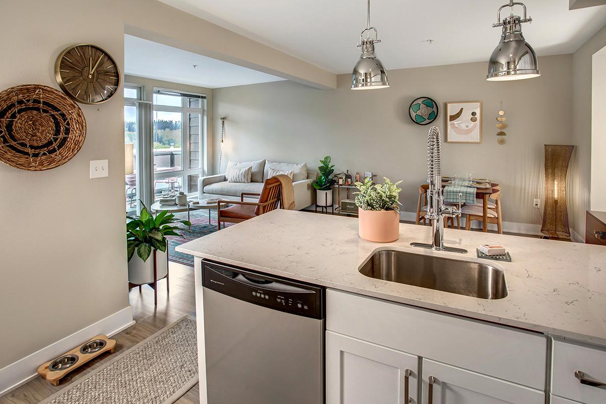 a kitchen with a sink and a mirror