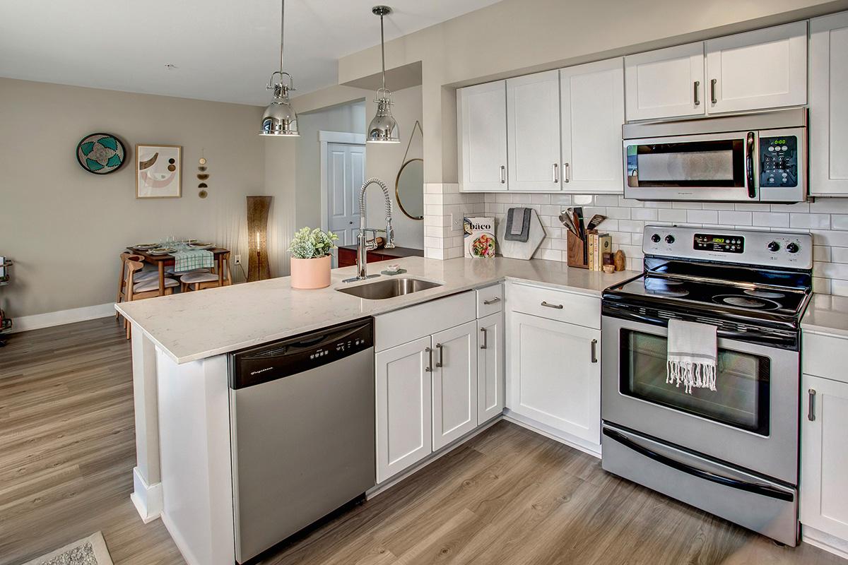 a stove top oven sitting inside of a kitchen