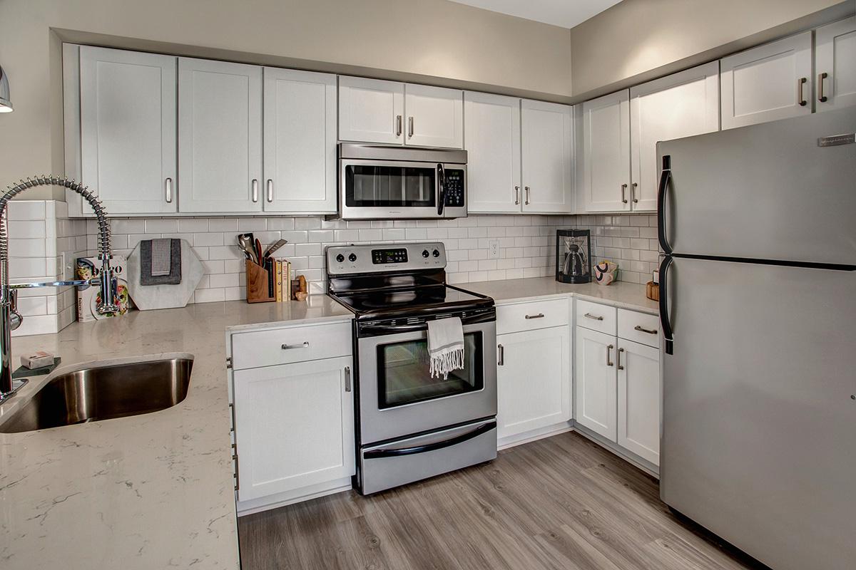 a kitchen with stainless steel appliances and wooden cabinets