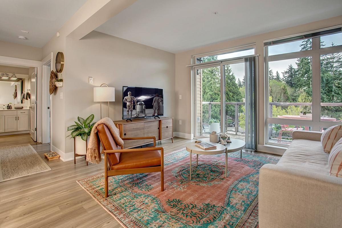 a living room filled with furniture and a large window