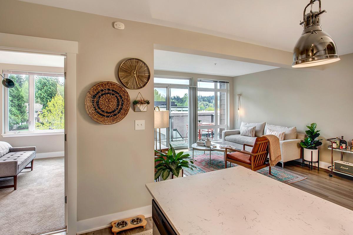 a living room filled with furniture and a large window