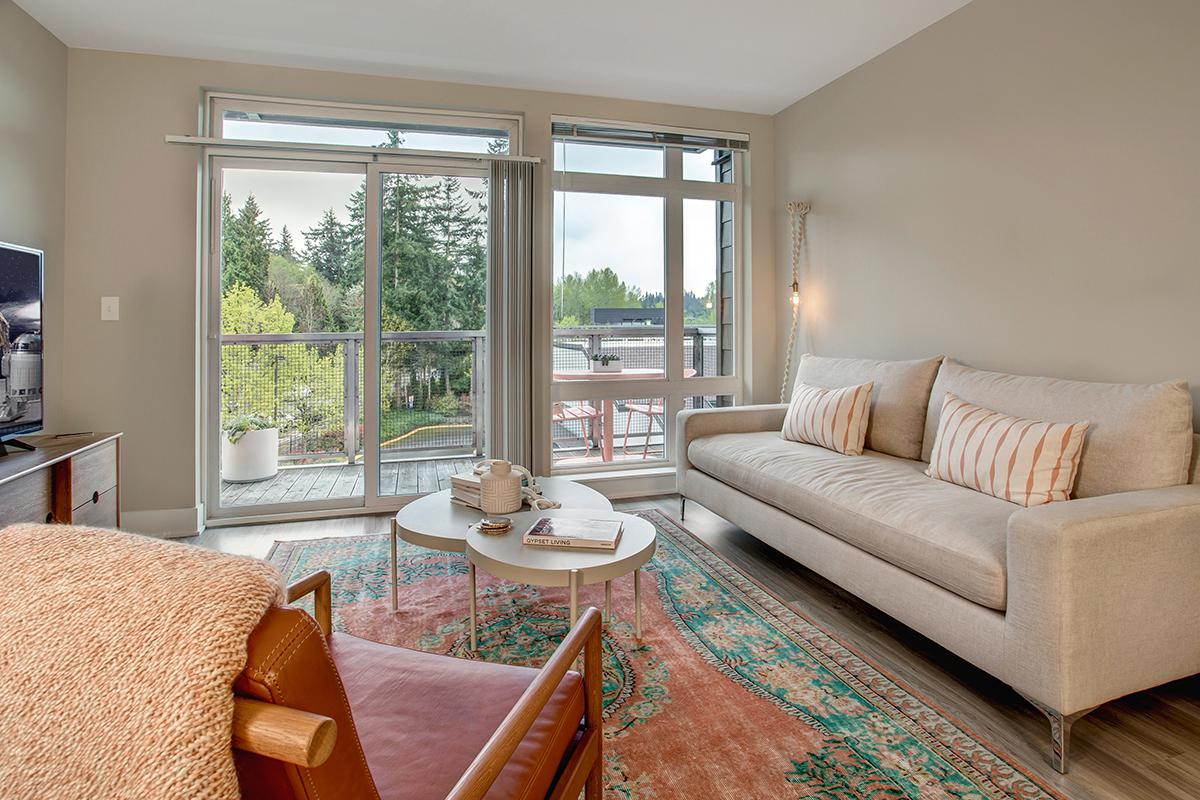 a living room filled with furniture and a large window