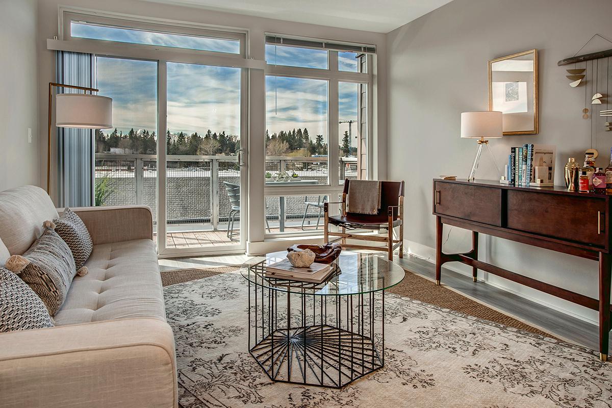 a living room filled with furniture and a large window