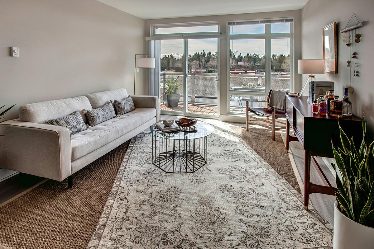 a living room filled with furniture and a large window