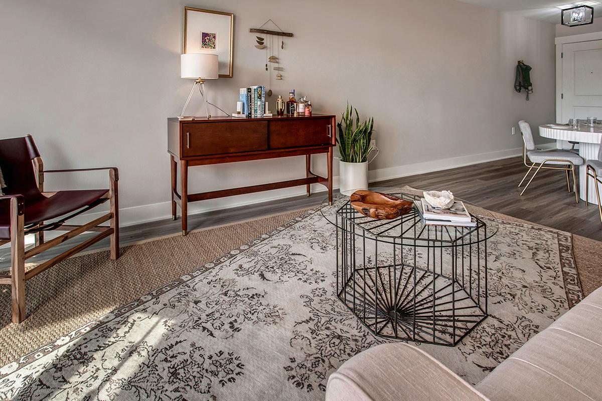 a living room filled with furniture and a flat screen tv