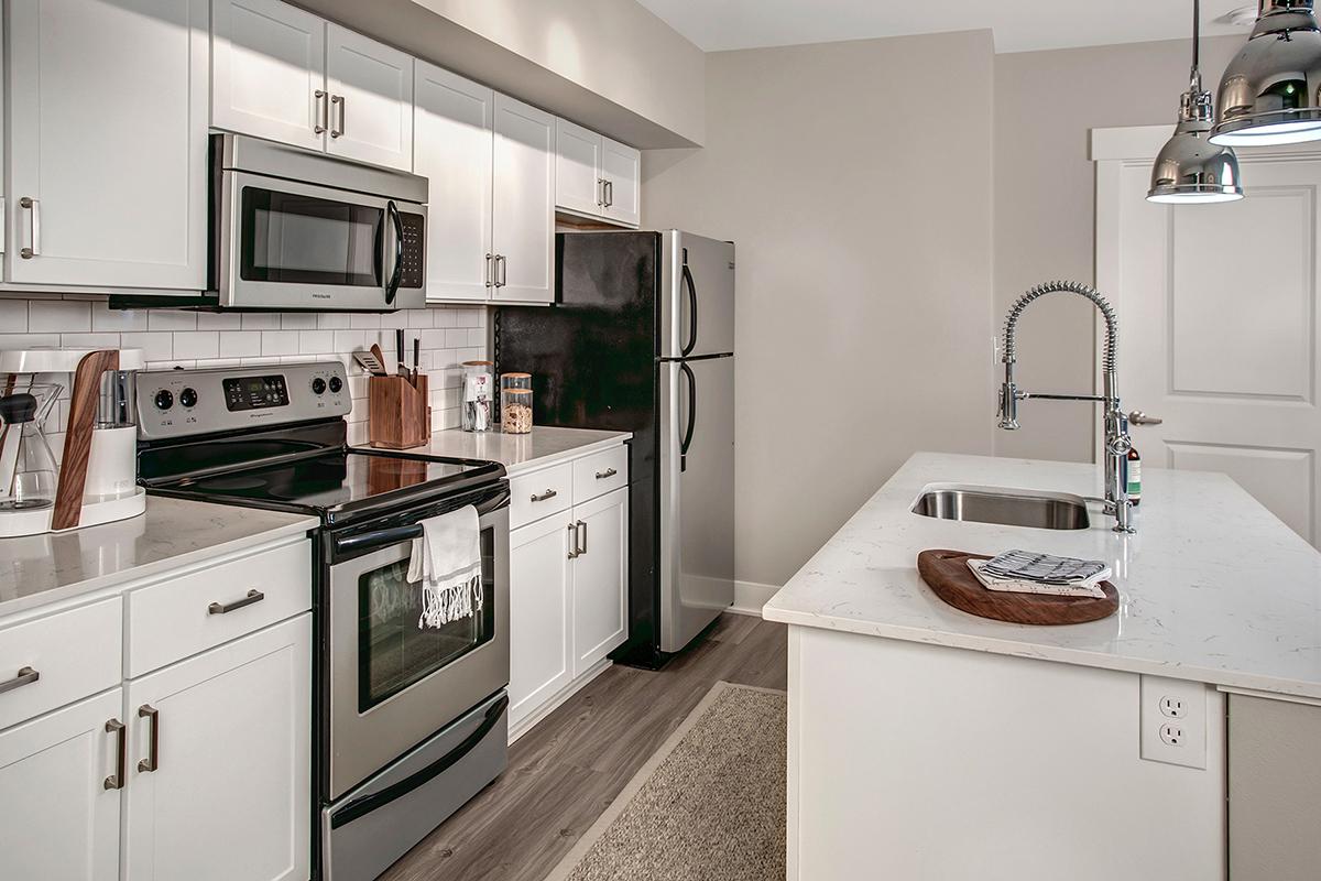 a kitchen with a stove a sink and a microwave