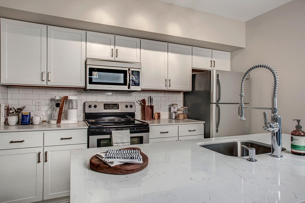 a large kitchen with stainless steel appliances