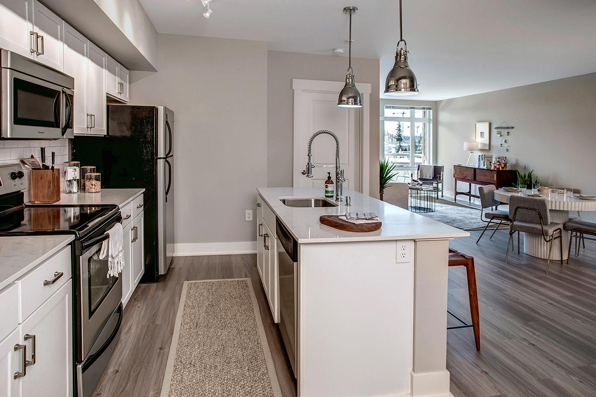 a kitchen with a stove sink and refrigerator