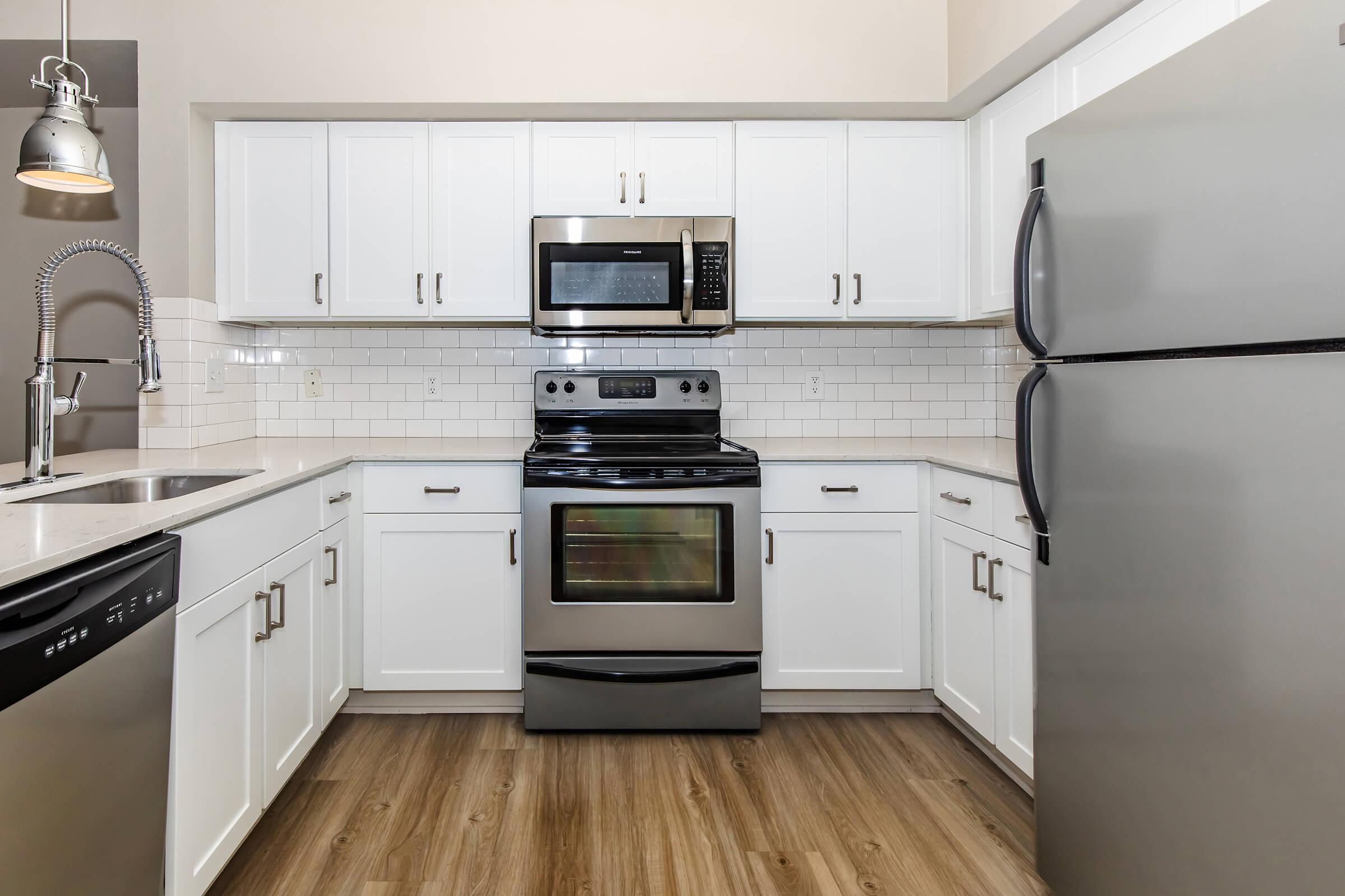 a stove top oven sitting inside of a kitchen