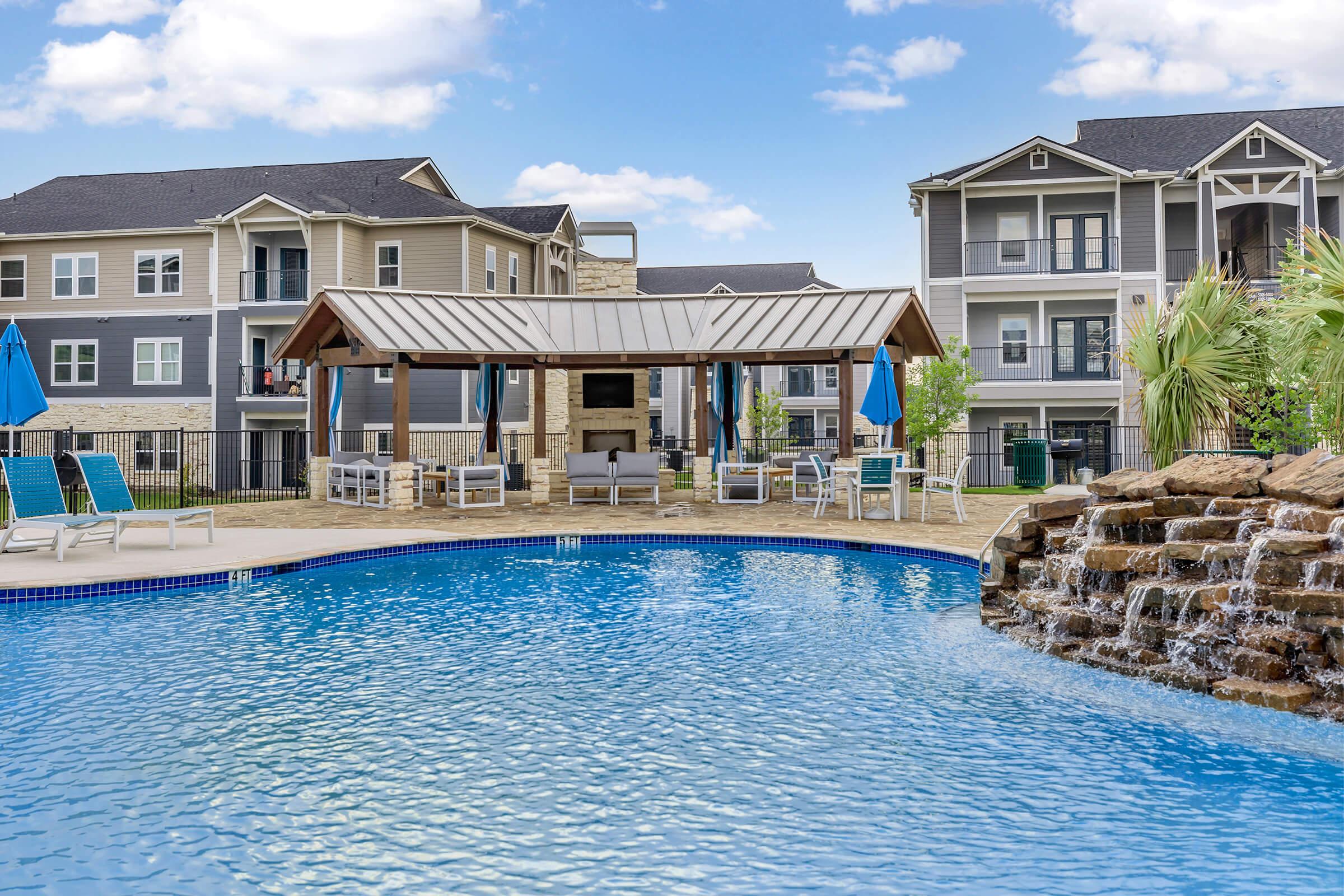 a large pool of water in front of a house