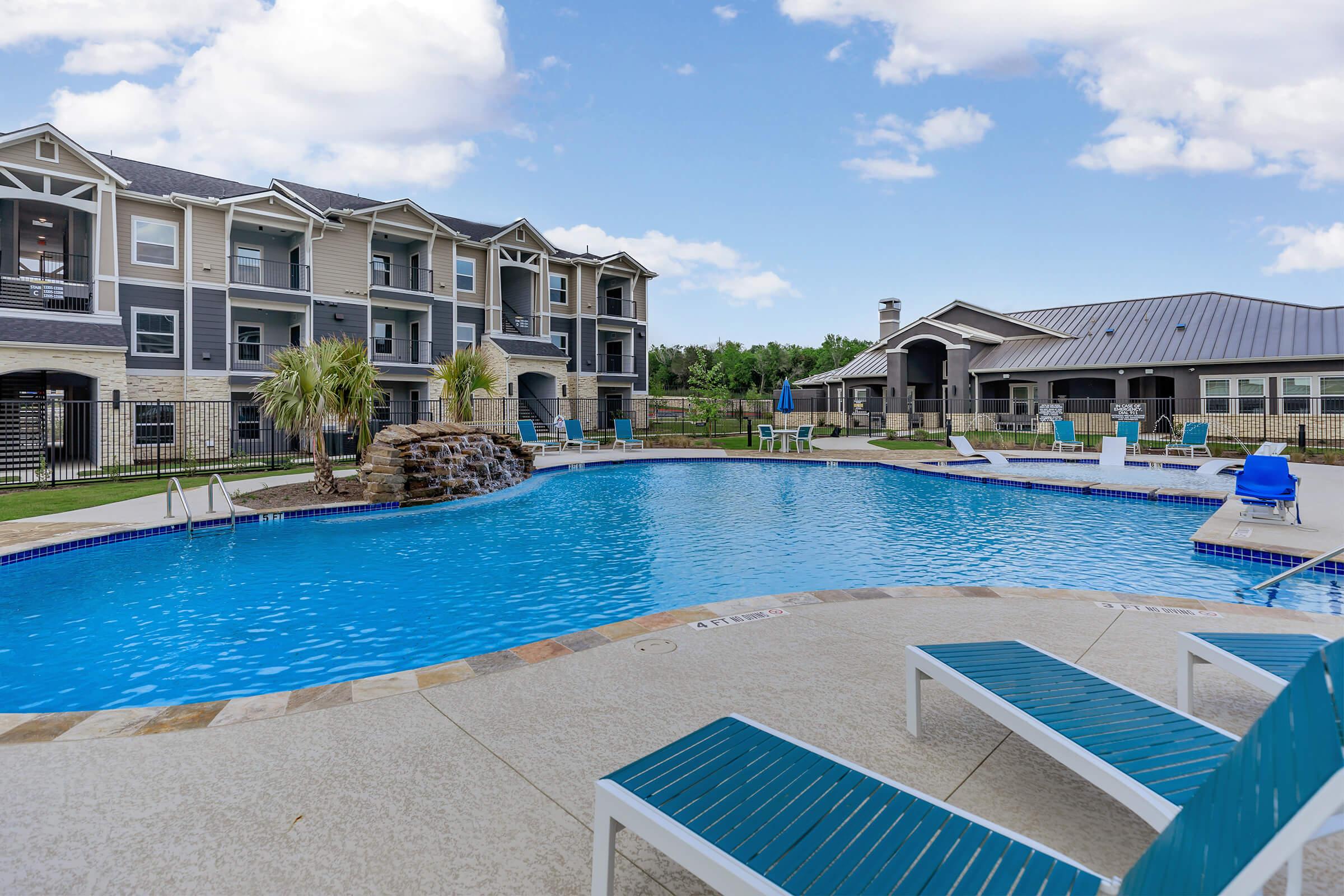 a large pool of water in front of a house