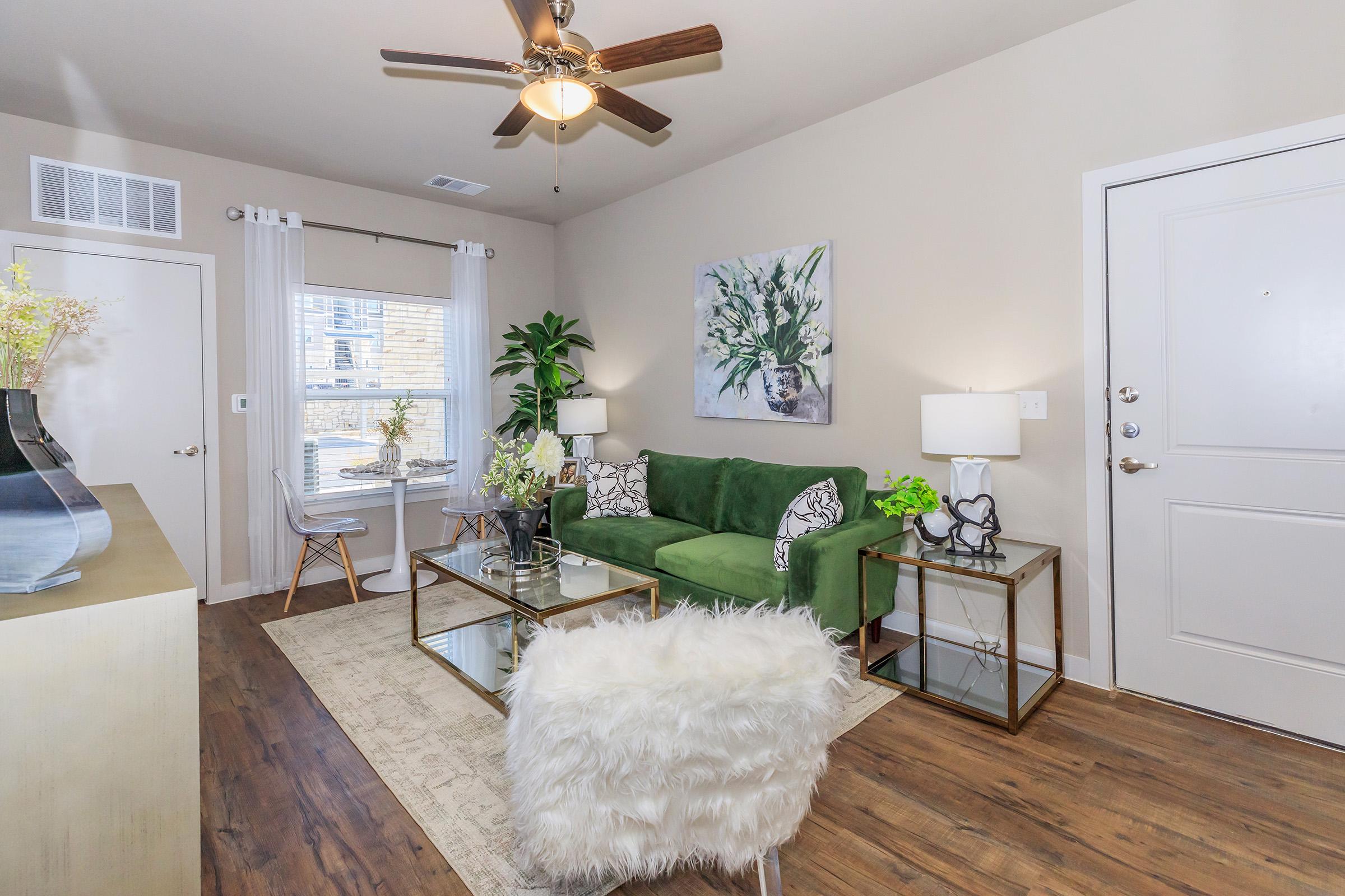 a living room filled with furniture and a large window